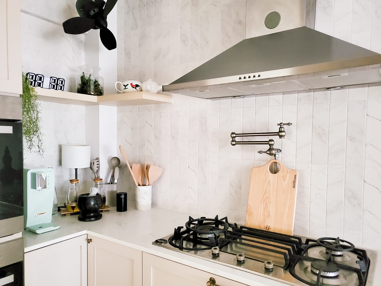 Combining the best of Kitchen Spaces and the English Countryside  - White marble tiles, modern kitchen, stainless steel range
