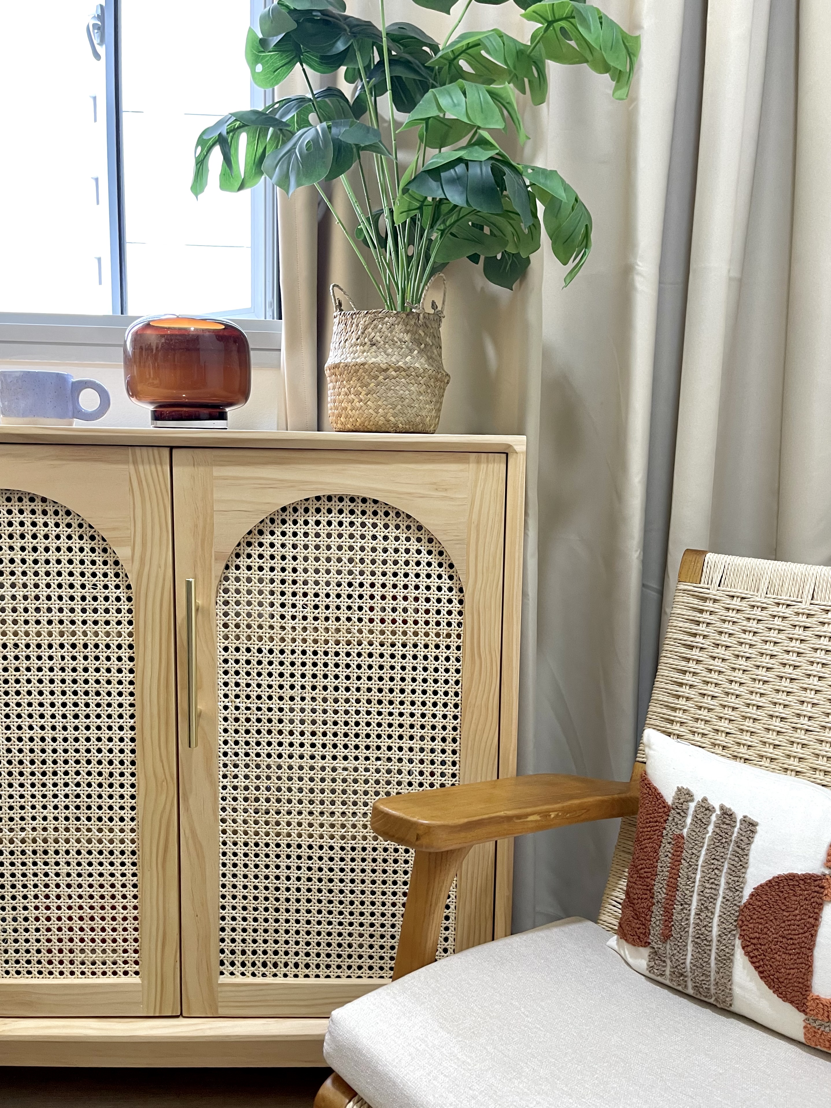 Different ways we styled our Cosy Corner - Light wood cabinet with intricate lattice design, beige cushion with textured