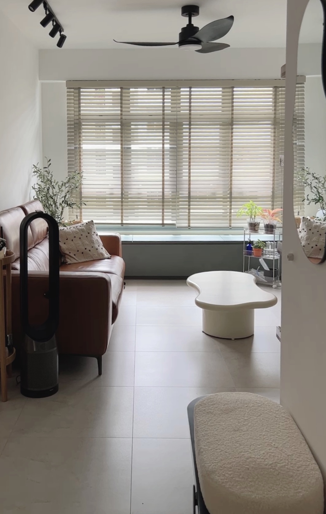 Our Simple but Cozy Living Room  - Modern living room with beige sofa, white coffee table, floor-to-ceiling windows with