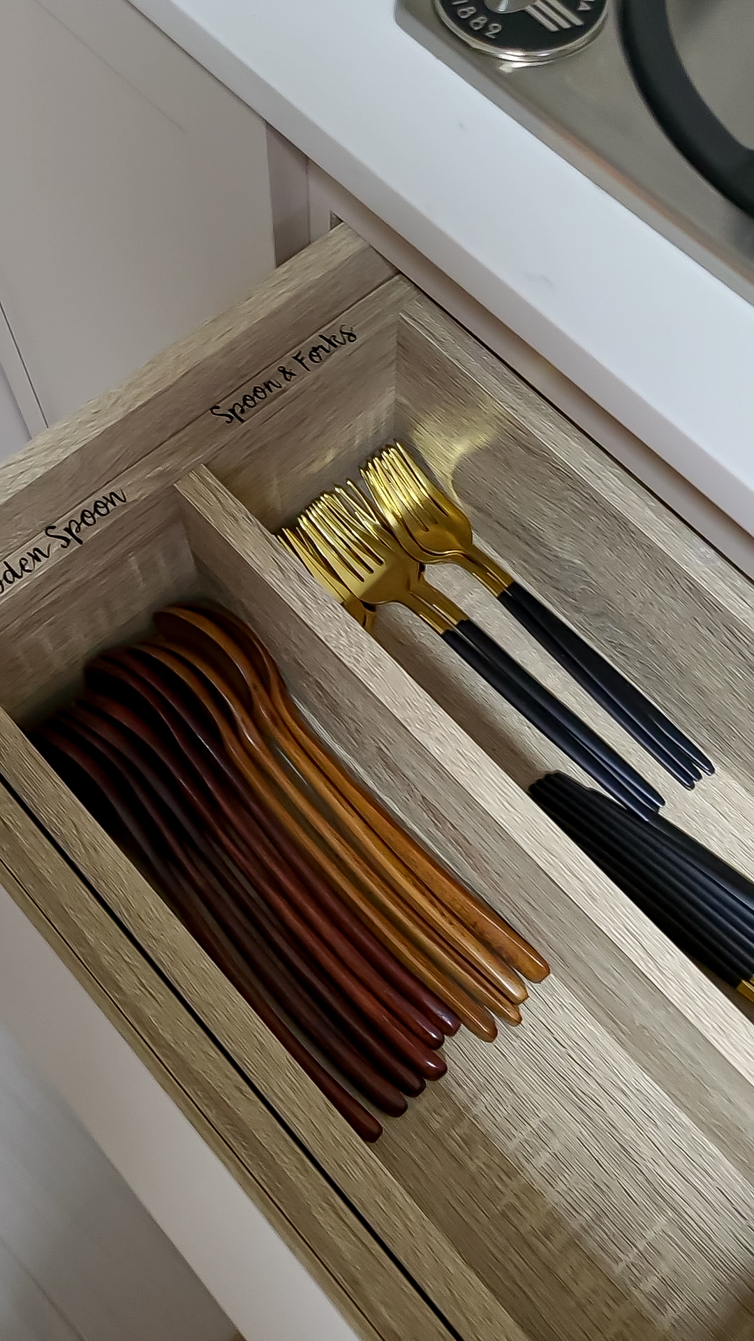 Fusing Aesthetics & Function For All Your Kitchen Storage Needs  - Wooden drawer with neatly organized utensils, including