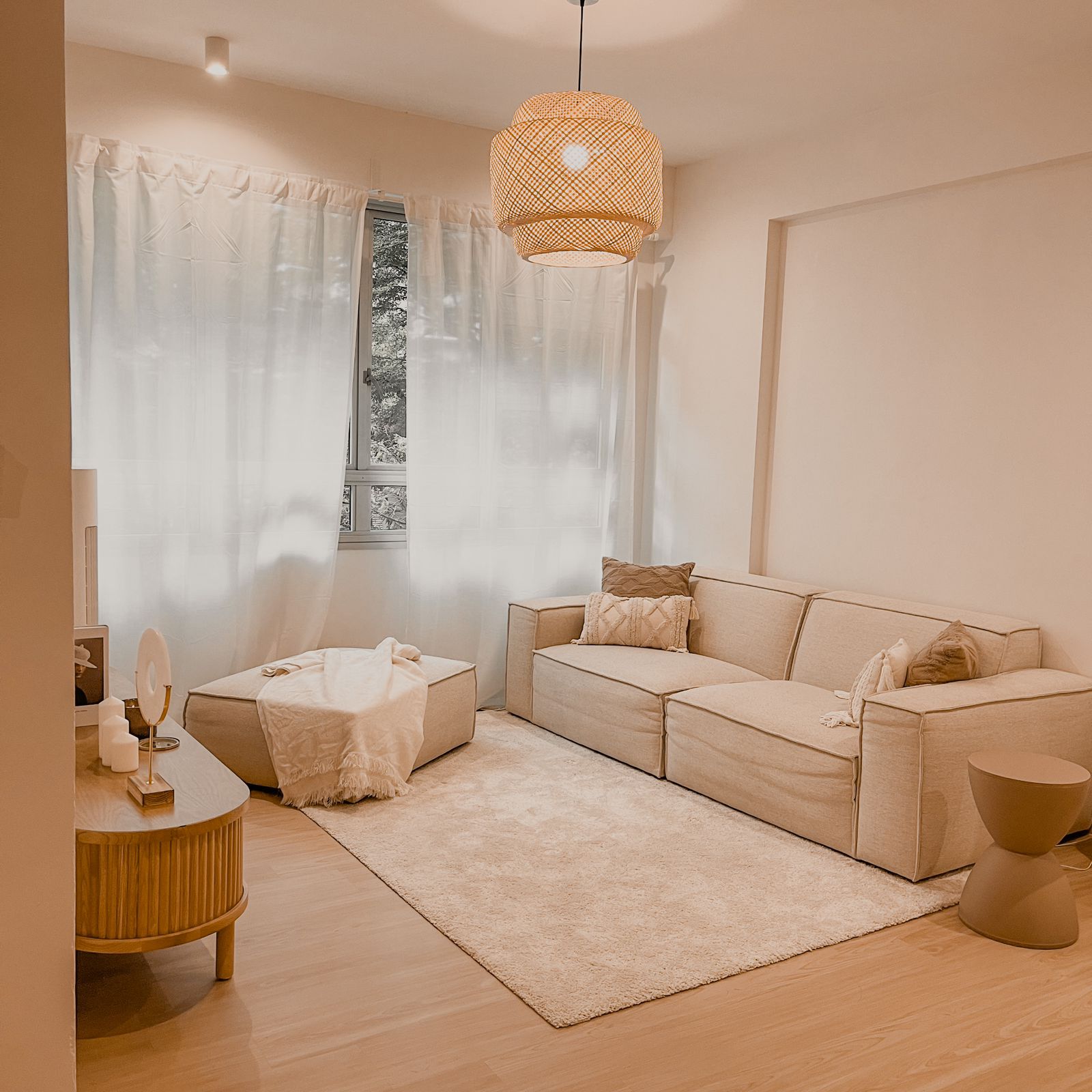 Spacious & Serene Living Room - Soft, neutral-toned living room, cozy seating area, beige sofa, plush rug, modern decor