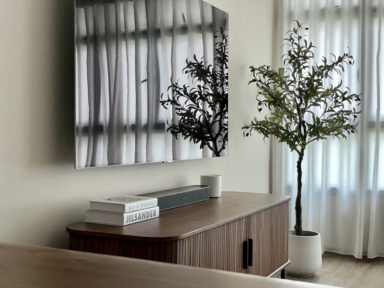 Minimalistic Living Room for all your Movie Nights - Modern minimalist living room, sleek TV stand, abstract black tree