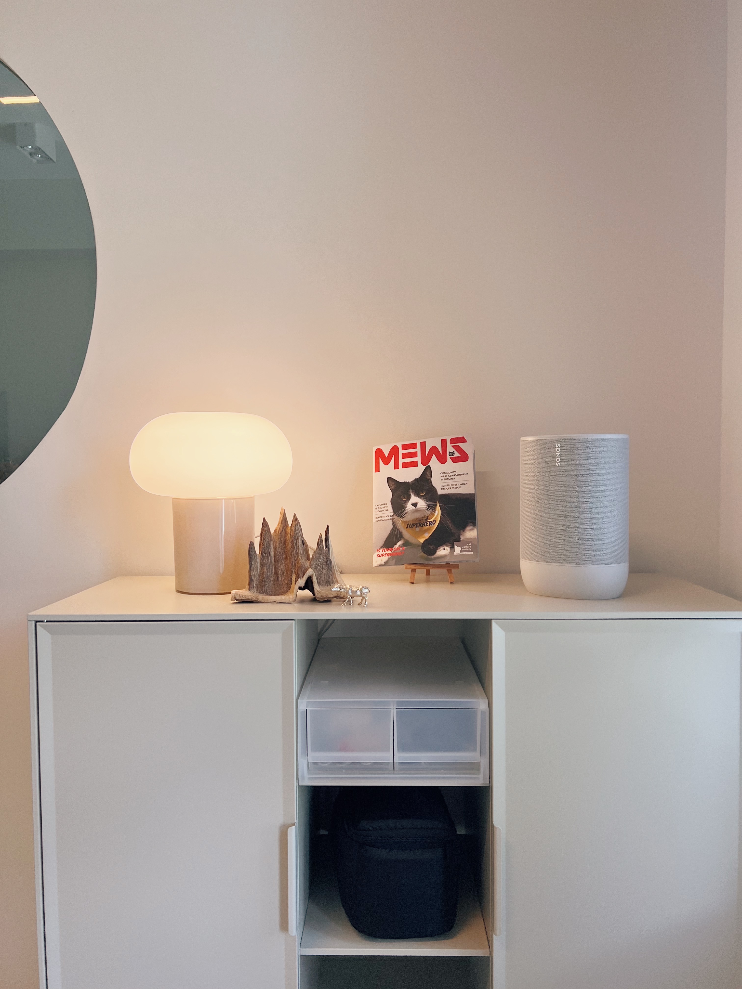 Finding focus in our home office - White minimalist cabinet, modern decor, soft lighting, magazine stand, cat-themed decor