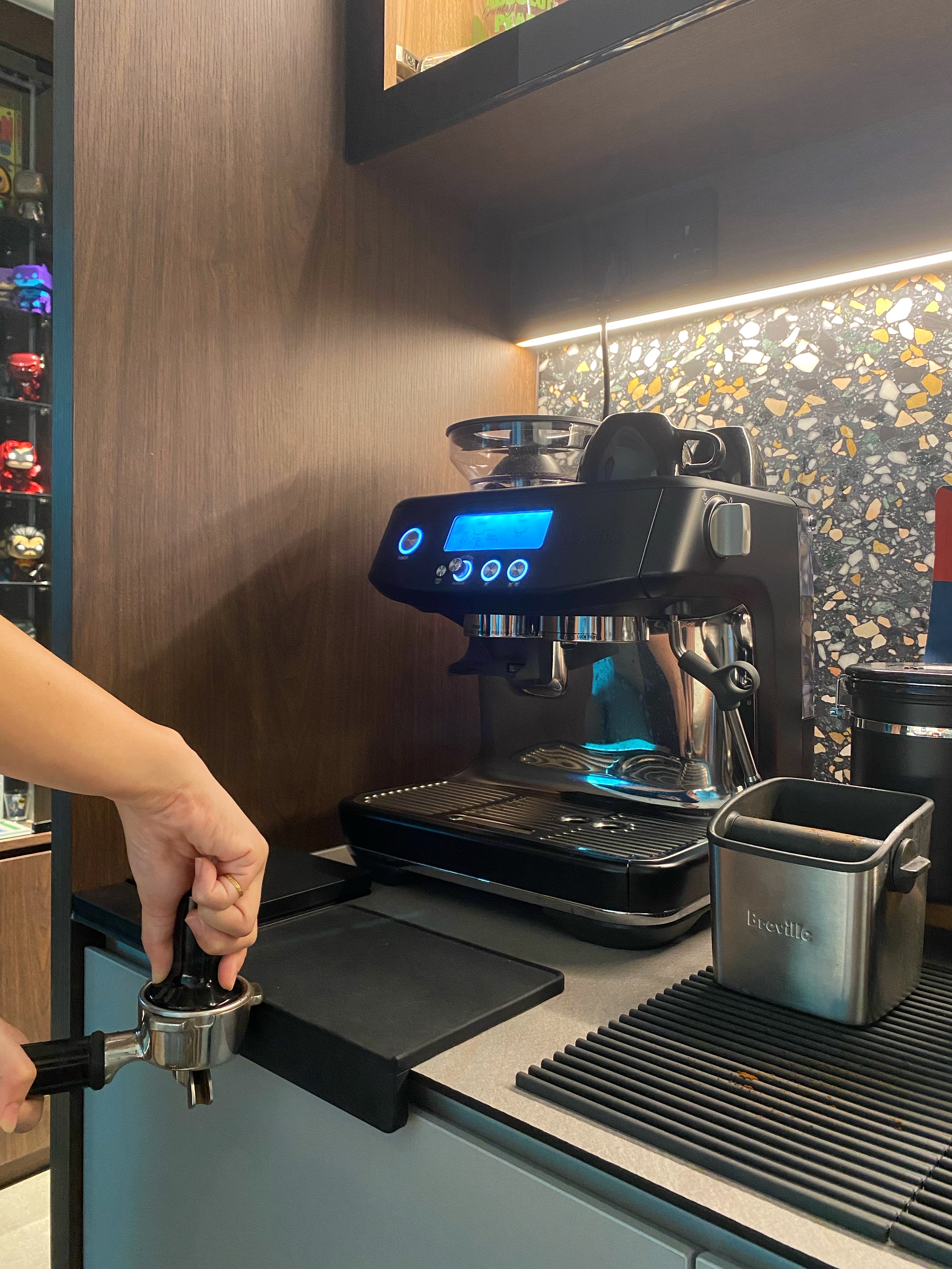 Our fun choice of morning routine - this is what we work hard for - black espresso machine, person preparing coffee, coffee