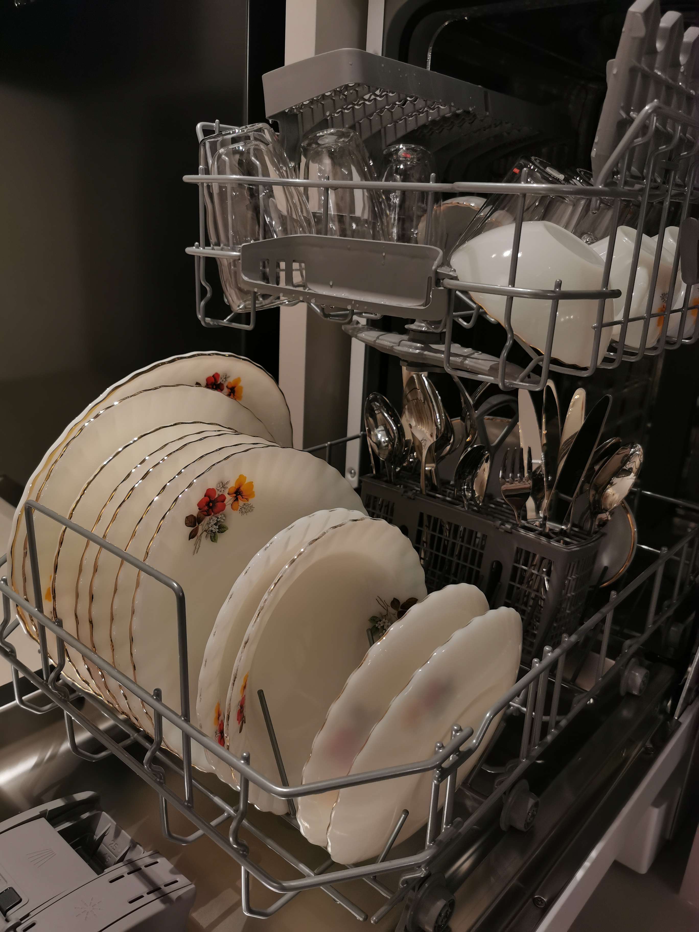 Transforming a 1980s wall kitchen - Dishwasher rack, glassware, stainless steel, dish drying, white plates, floral designs