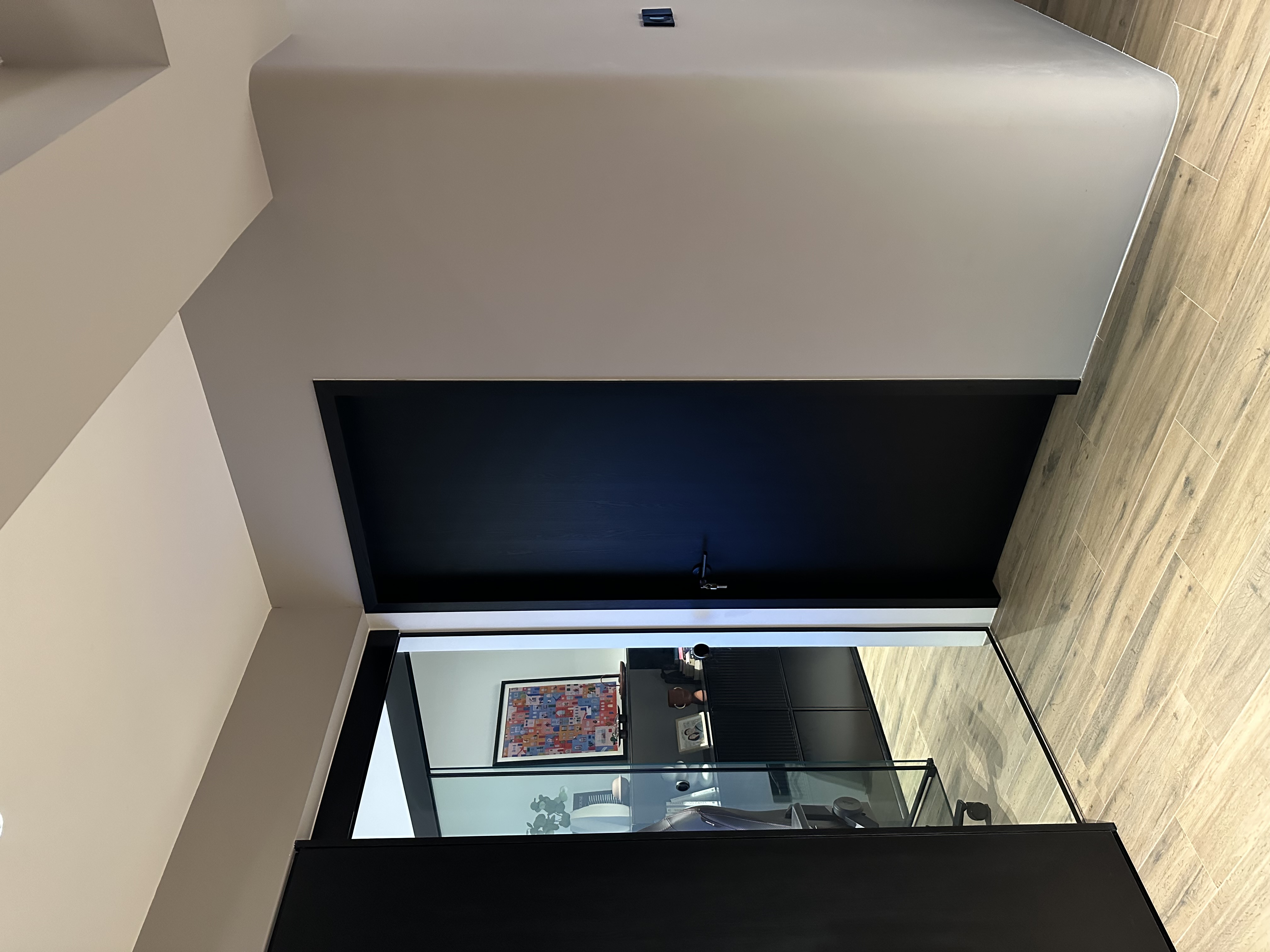 How to make a small minimalist study pod? - Modern minimalist interior, sleek black TV frame, glass-enclosed room, wooden