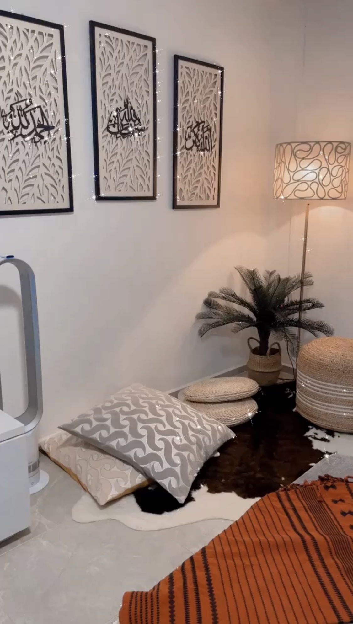 Eccentric Boho  - White wall, framed artwork, Arabic calligraphy, decorative lights, modern lamp, indoor plants, beige and