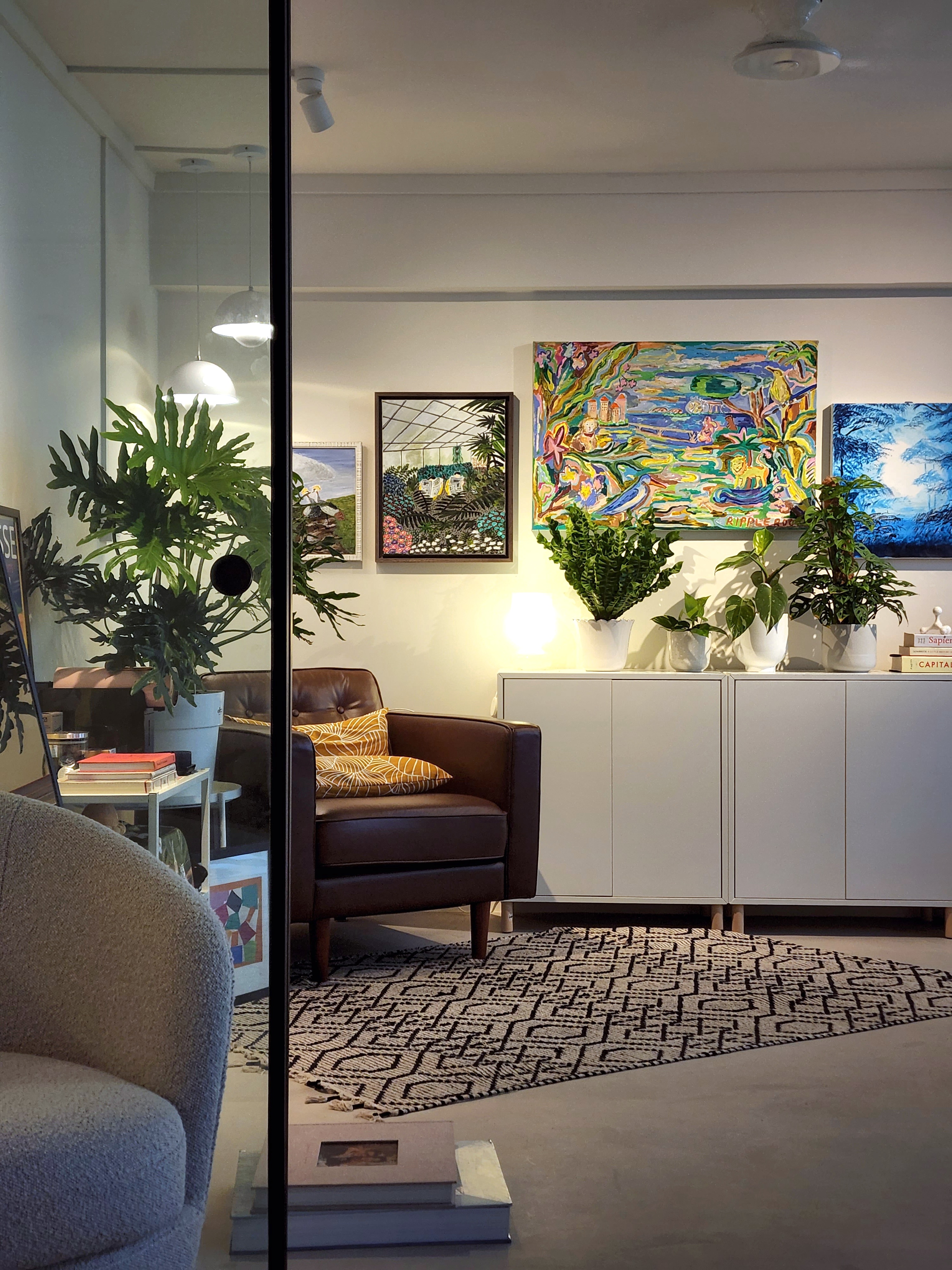 Study room or plant paradise? - modern living room, cozy seating, brown leather armchair, abstract paintings, colorful