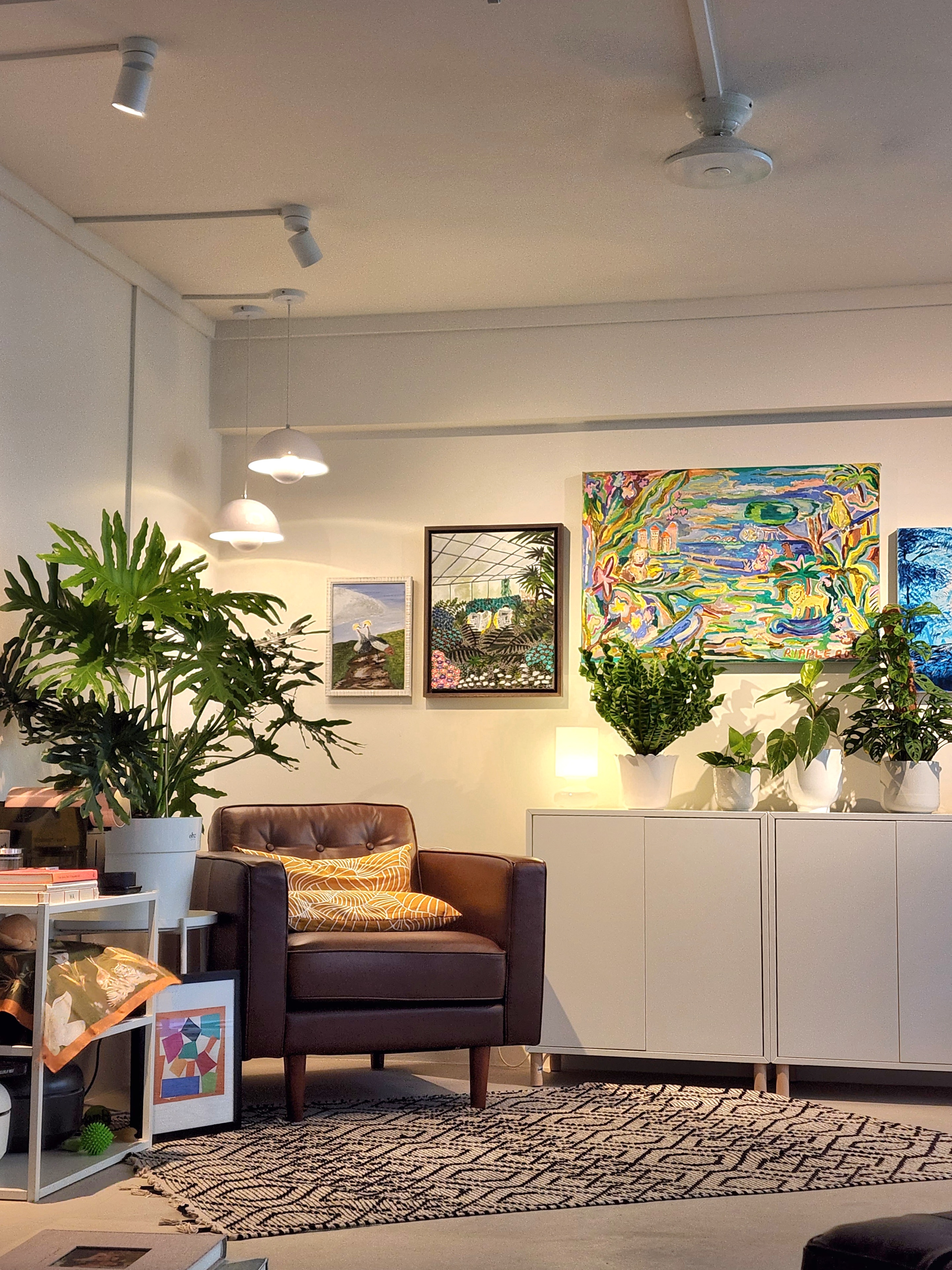 Study room or plant paradise? - Modern living room, cozy seating, brown leather armchair, yellow and white patterned pillow