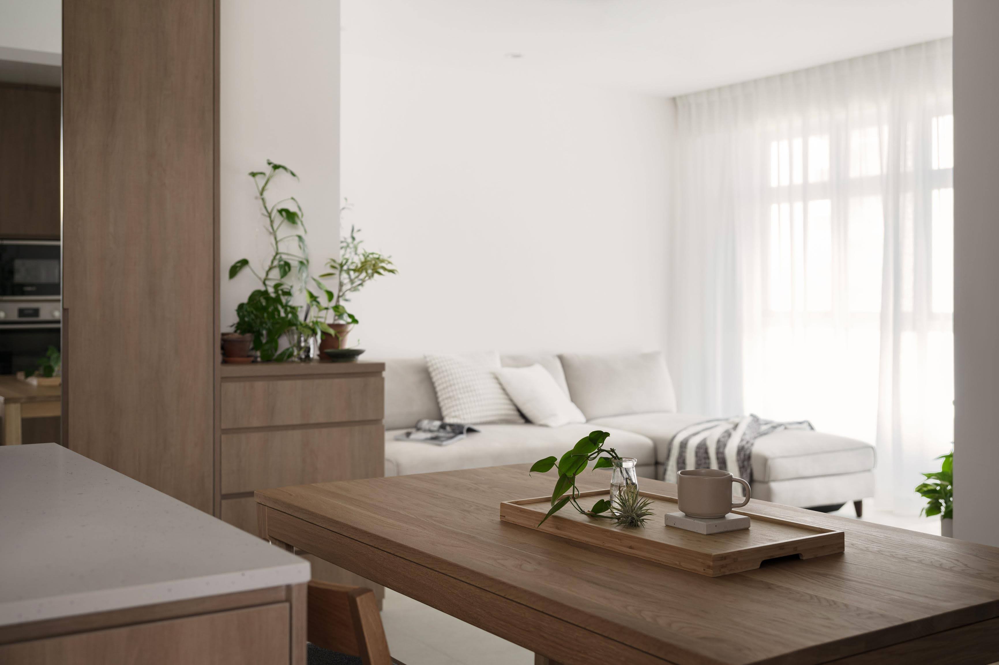 Our Calm and Cozy Japandi-themed Home - Modern minimalist living room, cozy coffee table, natural light streaming in, white