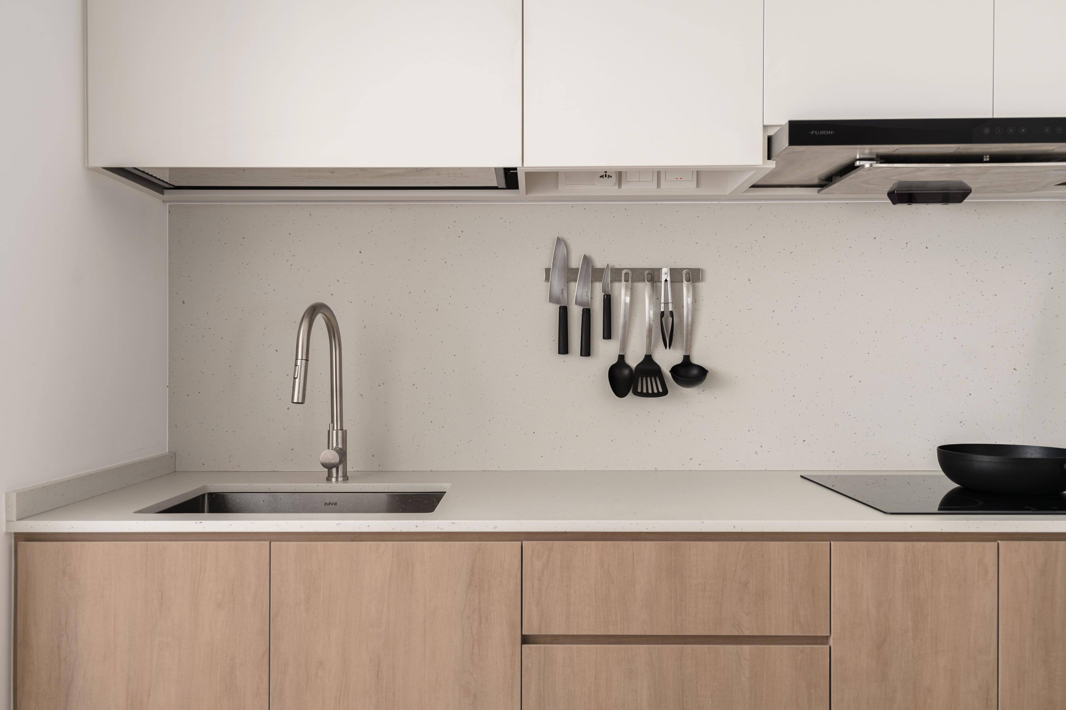 Our Calm and Cozy Japandi-themed Home - White kitchen cabinets, stainless steel sink, light wood countertops, modern kitchen