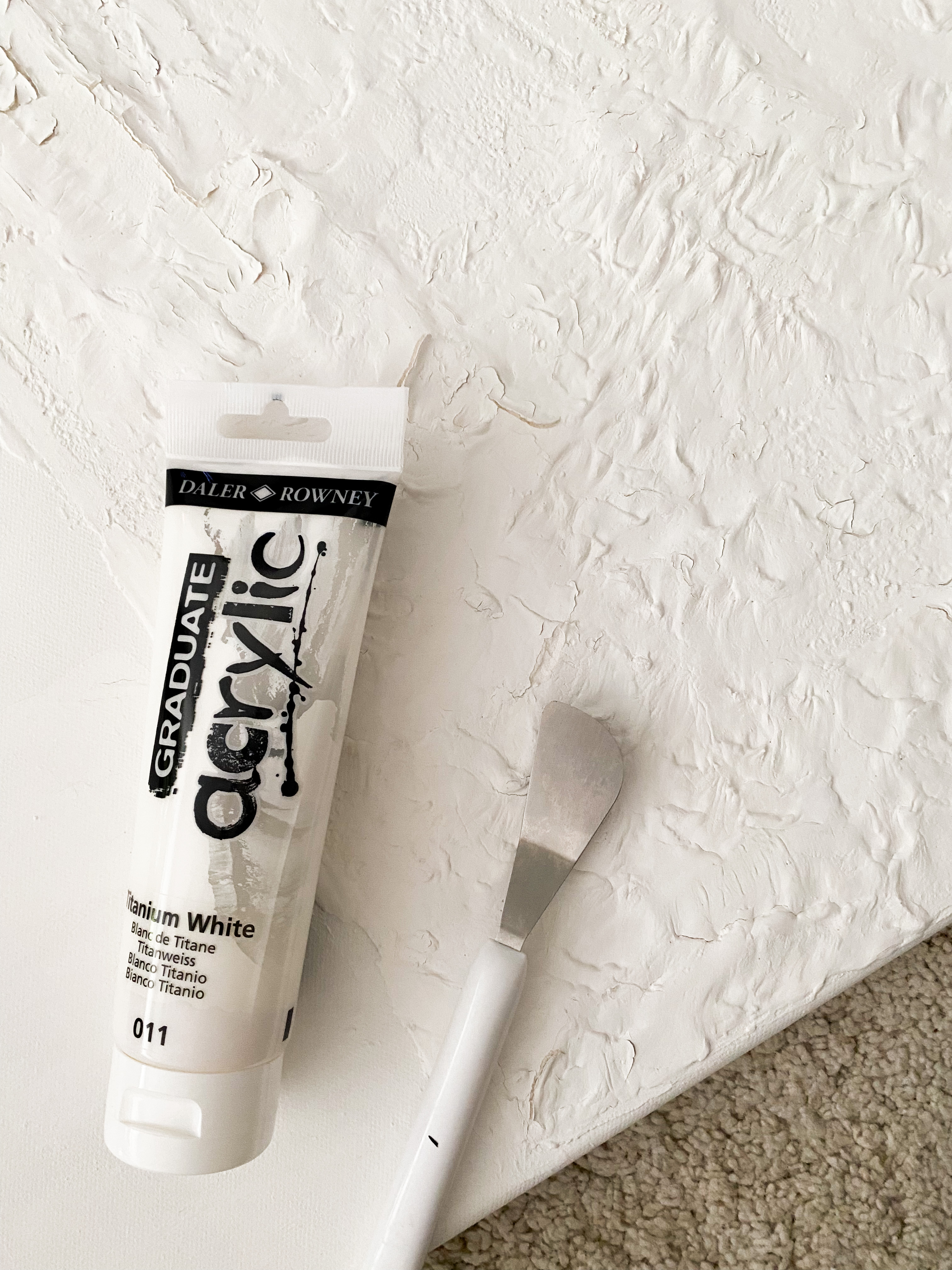 Creating your Masterpiece with Textured Plaster Art  - White textured wall, acrylic paint tube, Daler Real, Rowney, Titanium