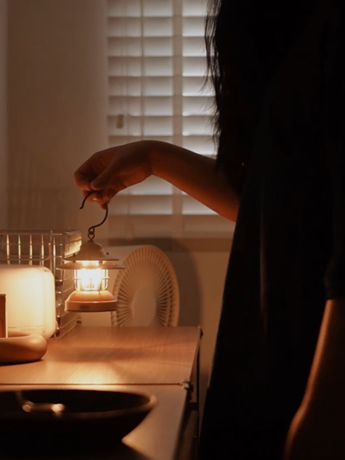 Day to Night Comfort Routine in a Cozy Room - dimly lit room, lantern, warm light, person holding lantern, dark silhouette