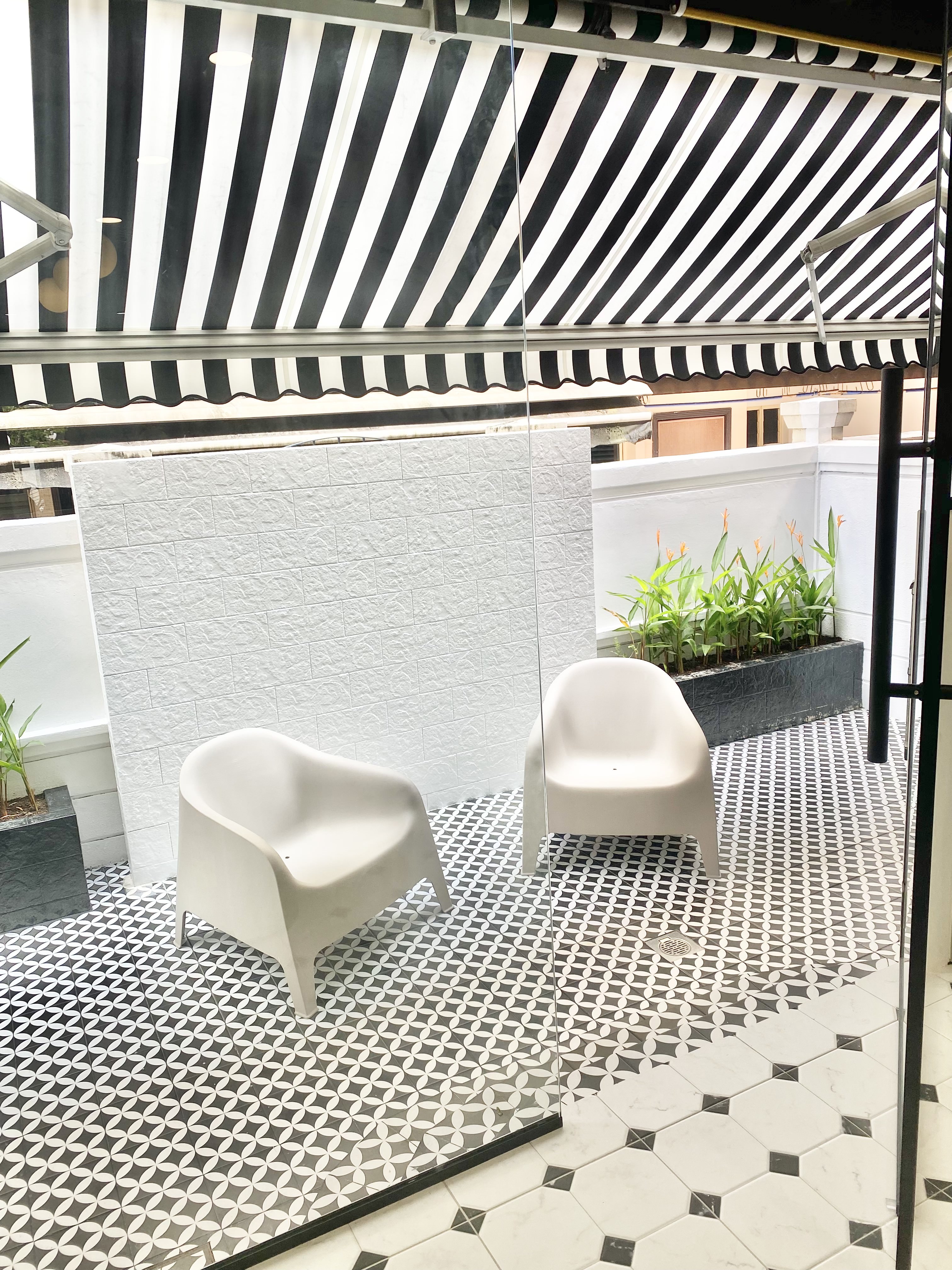 A Black & White Scandi, Peranakan and Colonial-inspired Inter-terrace - black and white striped awning, modern patio