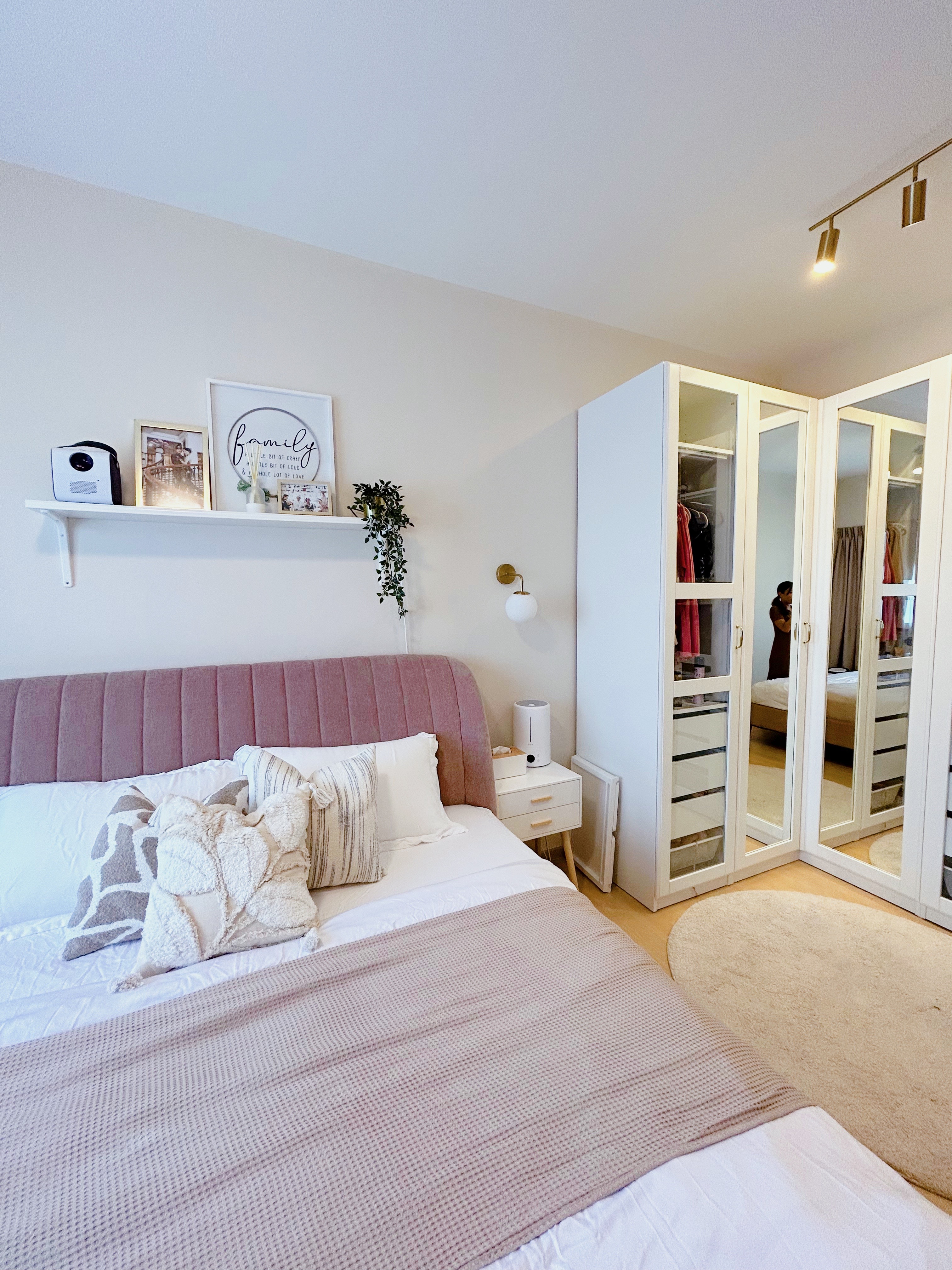 Our cosy master bedroom  - White and pink upholstered headboard, neatly made bed with beige and white bedding, plush pillows