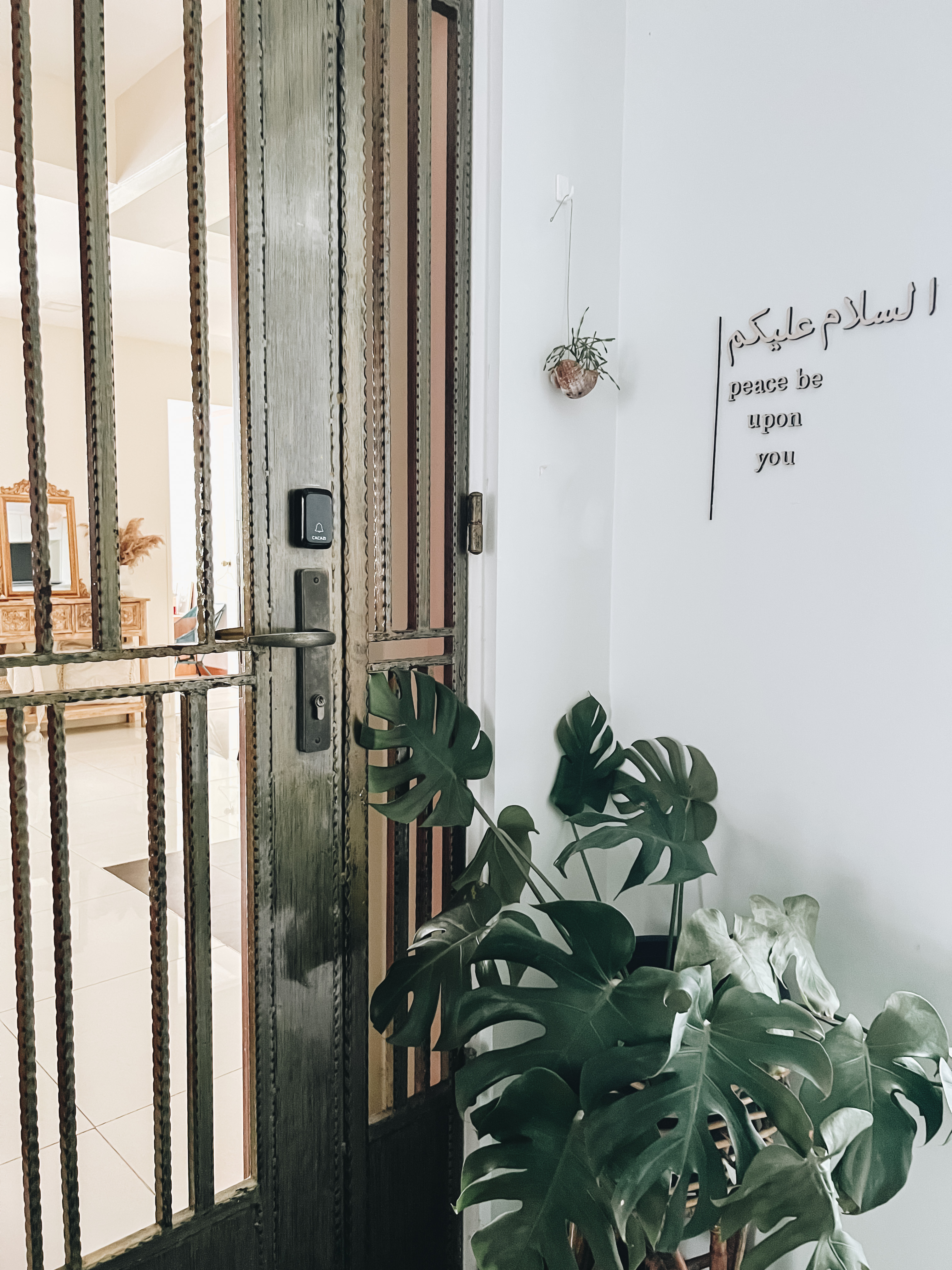 Make a great impression in your foyer/entryway - metallic bars, rustic door, ornate door handle, textured wall, modern