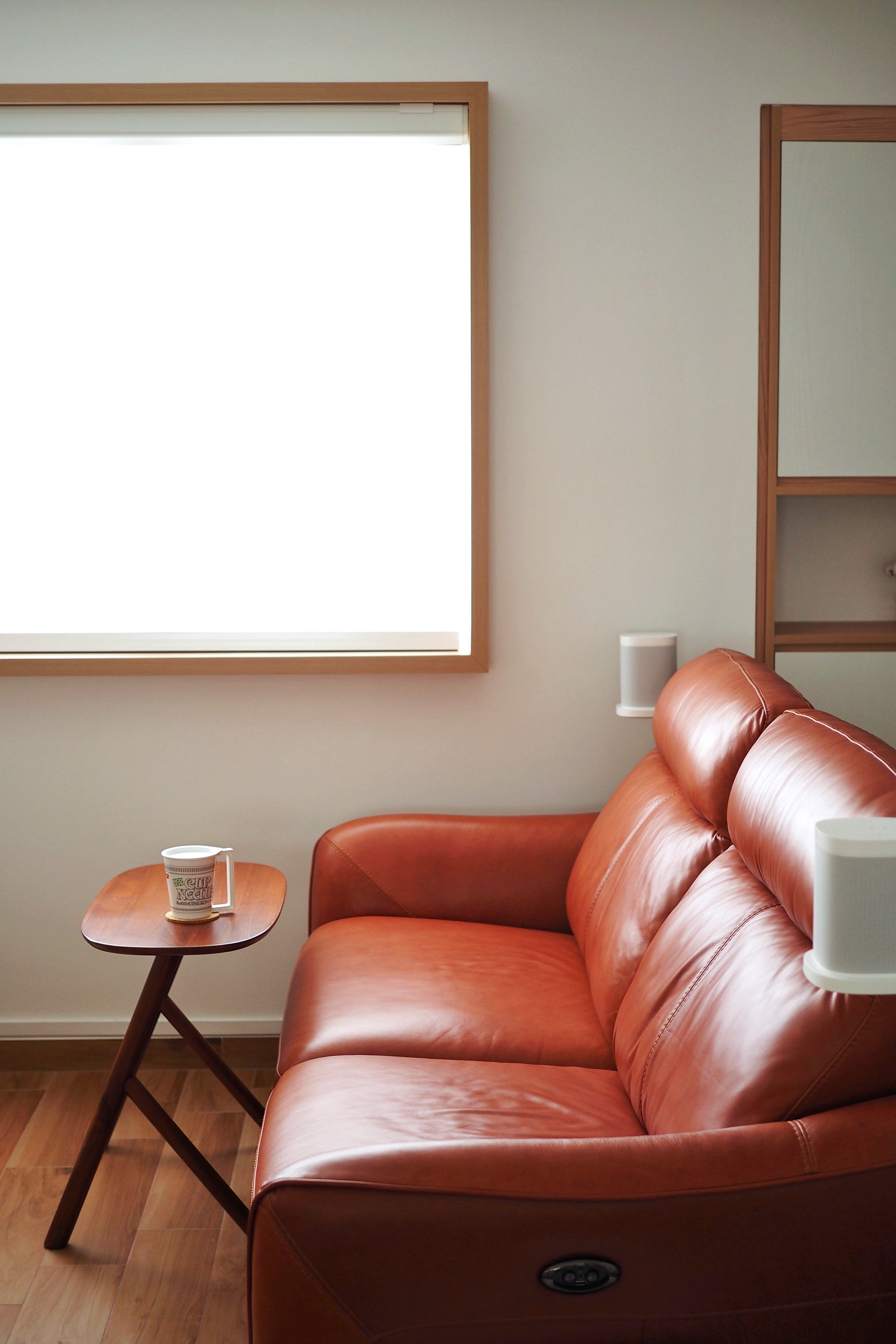 Heart of Our Home — Living Room - Modern minimalist living room, cozy seating area, orange leather sofa, wooden side table