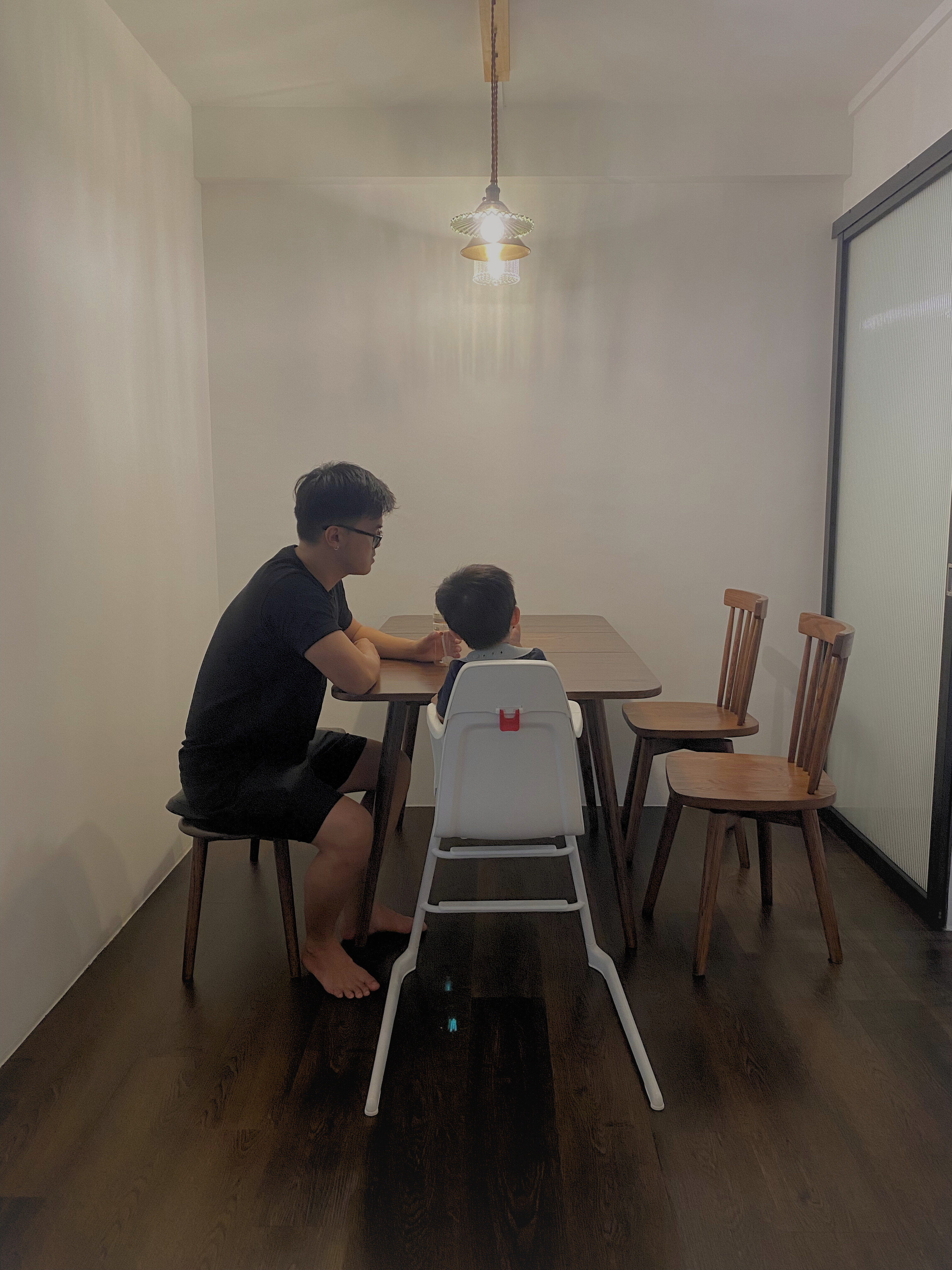 Dining Room For Family of 3 - Minimalist dining room, wooden table, two adults and child, wooden chairs, white child seat