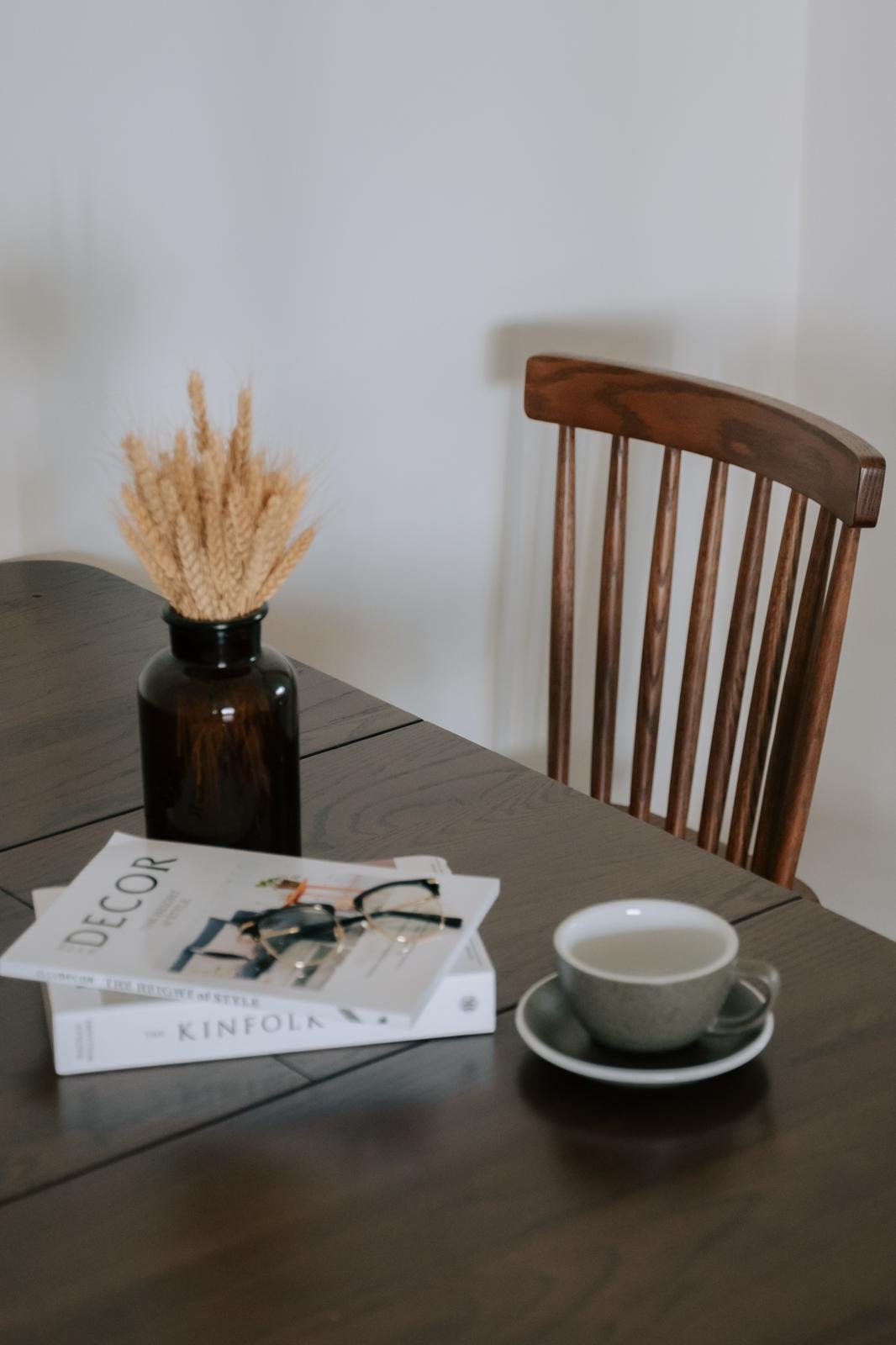 Dining Room For Family of 3 - vintage wooden table, rustic decor, cozy setting, wooden chair, natural light, minimalist