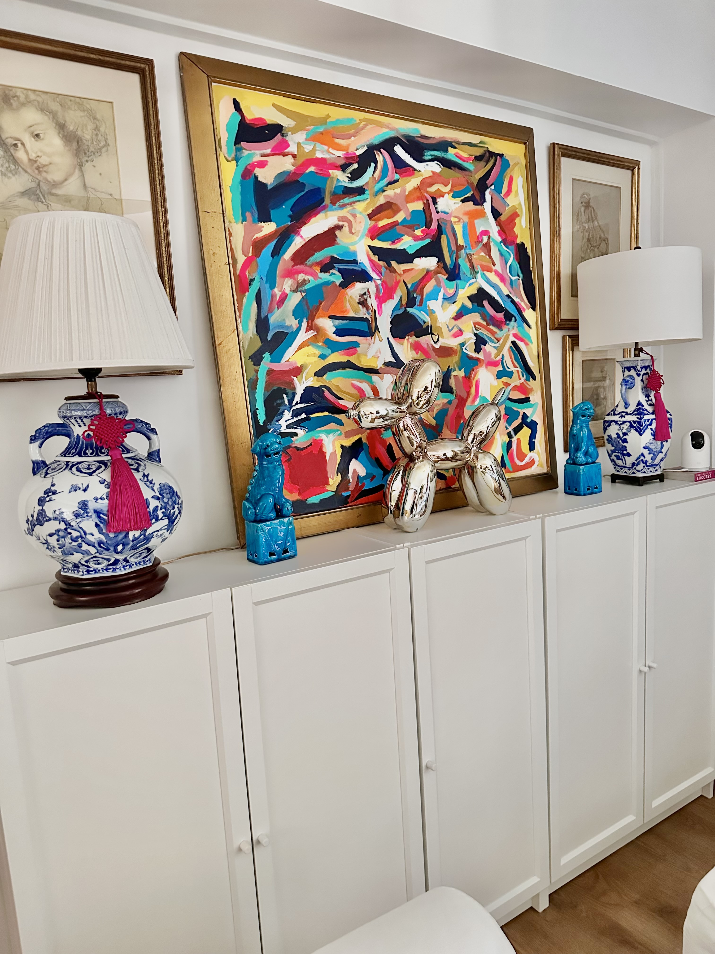 Self-designed maximalist home in Tiong Bahru - vibrant abstract painting, blue and white vase, blue figurine, white cabinet