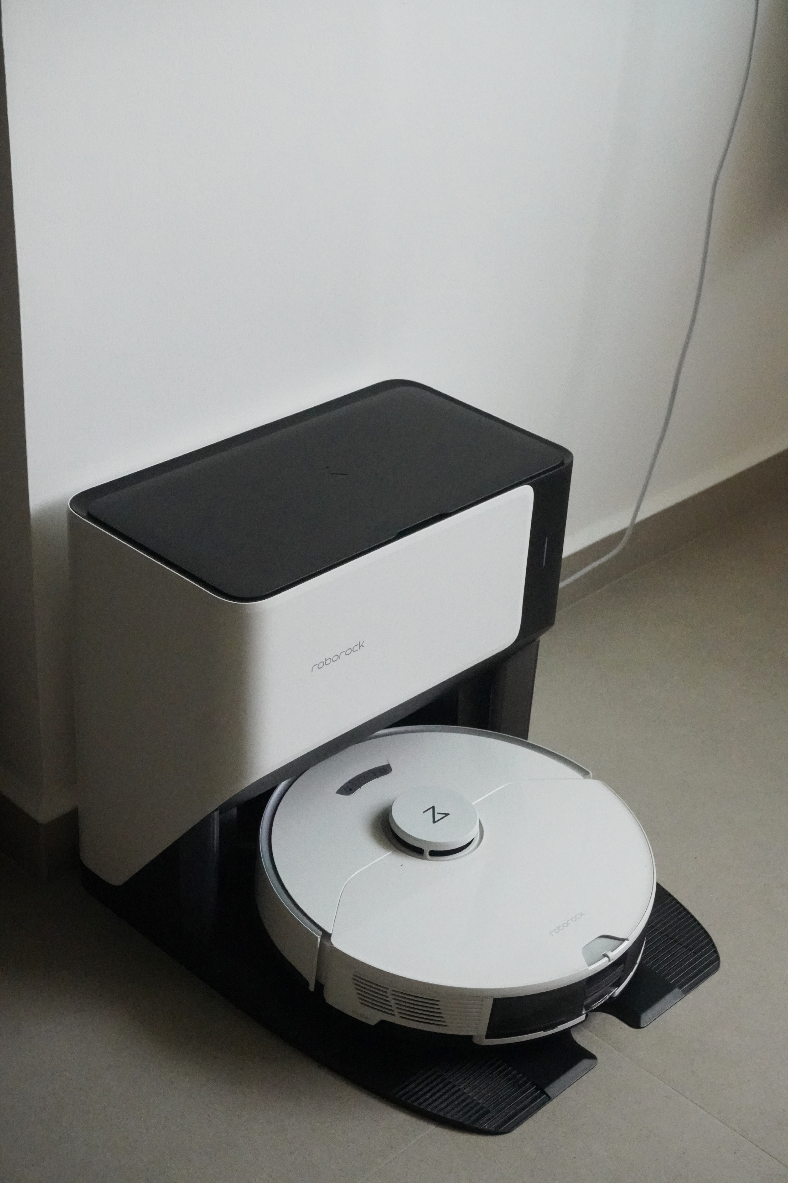 Just focus on the view: Our simple service yard - Robotic vacuum cleaner, sleek design, white and black color scheme, compact