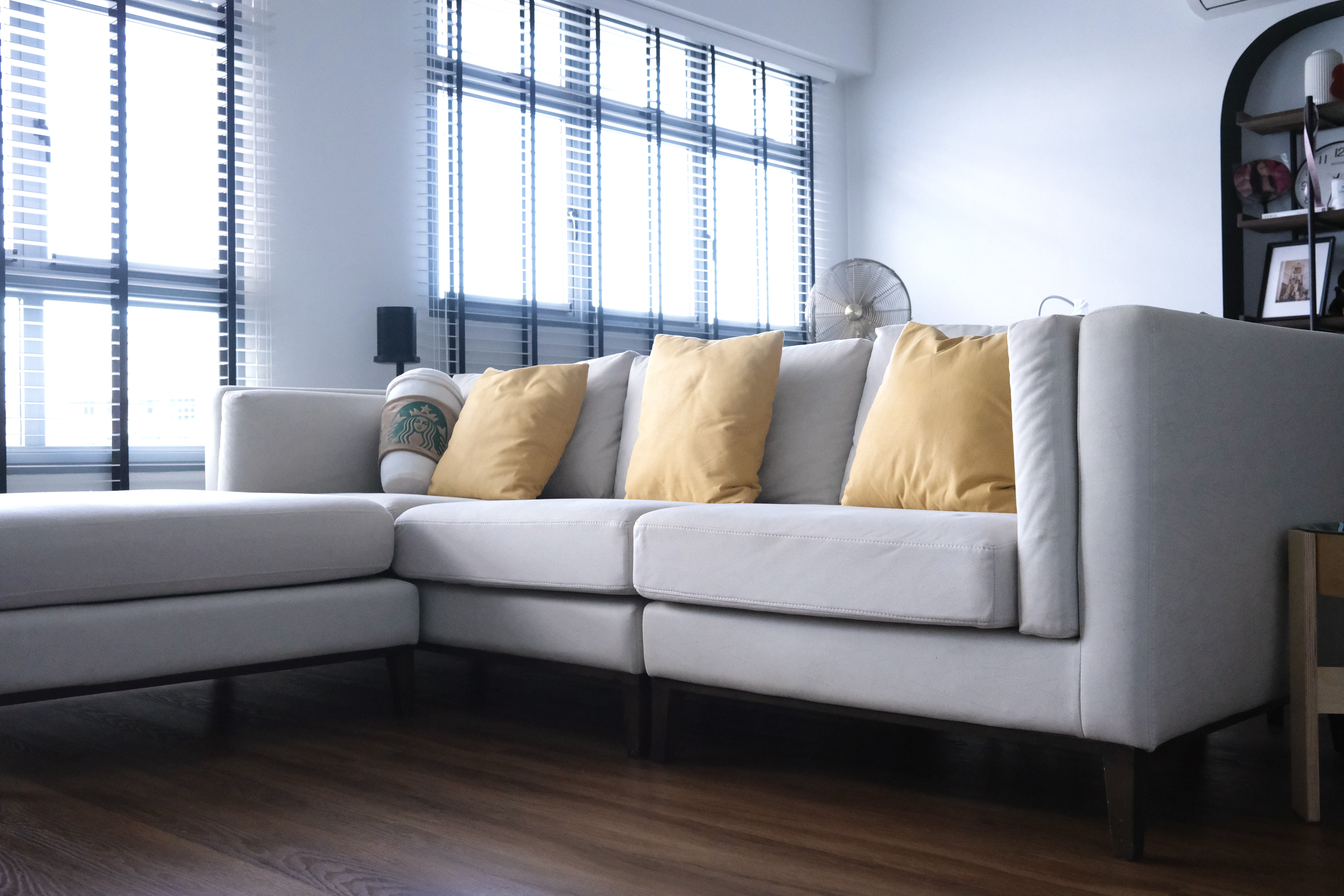 Our Living Room | Where we Netflix & Chill - Modern living room, cozy sofa, light gray fabric, yellow accent pillows, large
