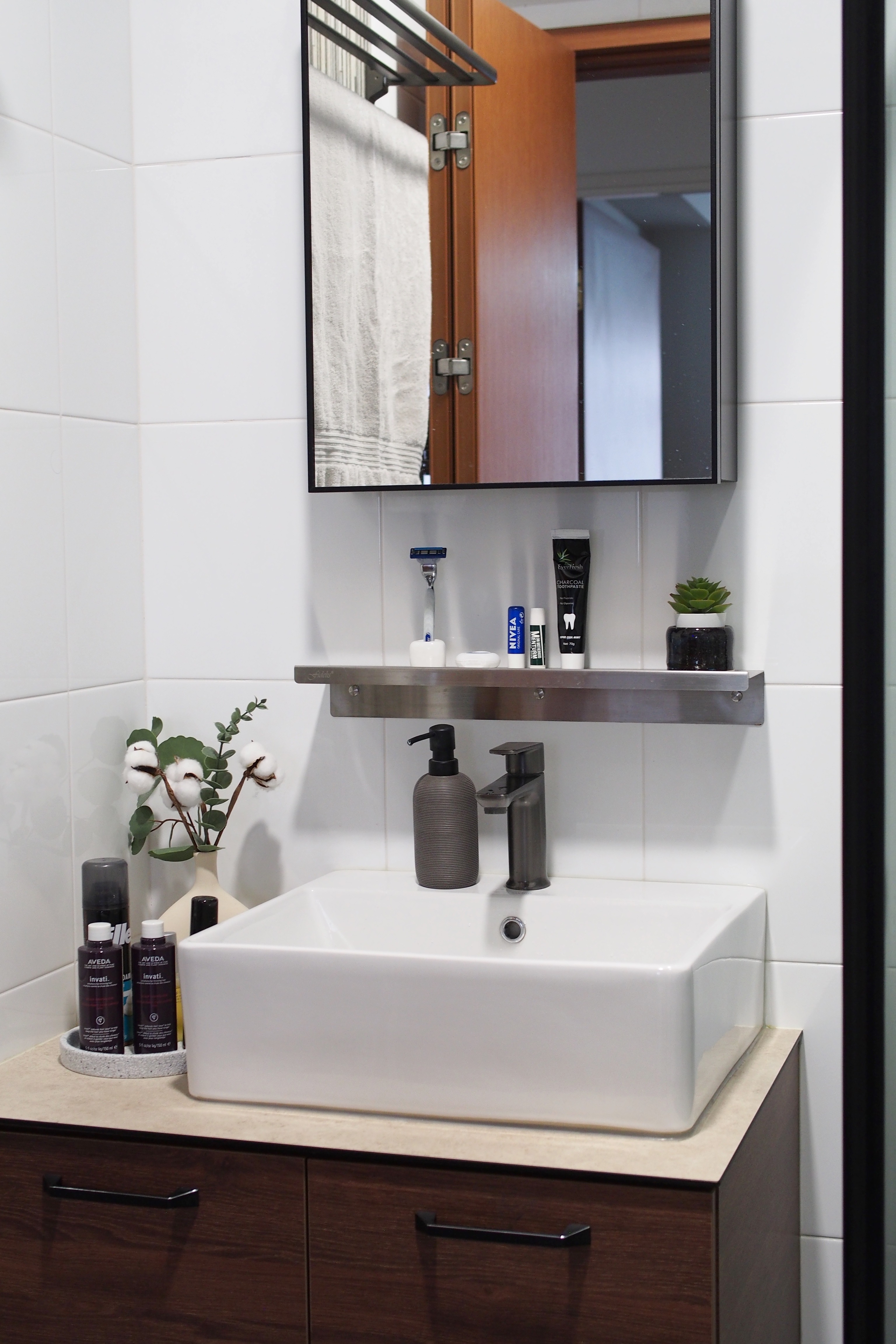Making a bathroom with HDB fittings work - White bathroom vanity, modern design, white tiles, wooden cabinet, black handles