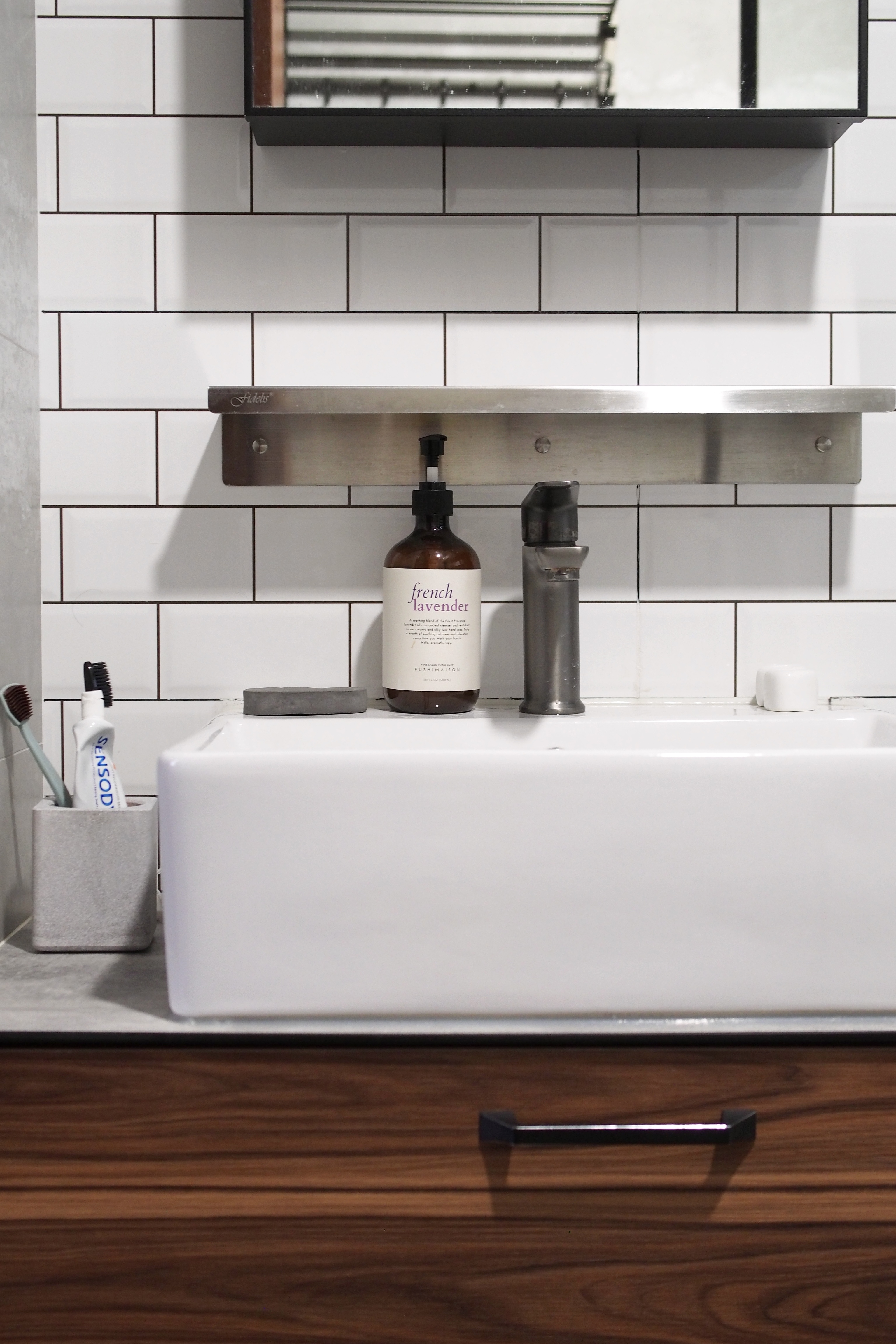 Making a bathroom with HDB fittings work - silver sink, white tiles, modern bathroom, mirror, stainless steel faucet, wooden