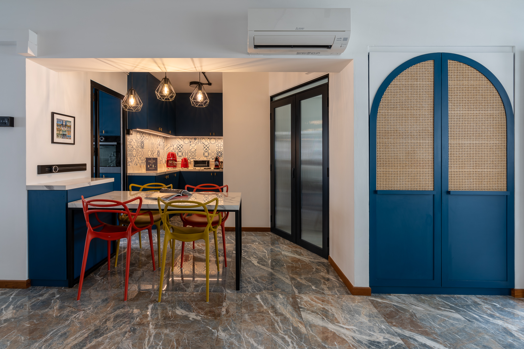 Designing a flexible dining setup - Modern kitchen with blue cabinets, marble floor, colorful chairs, air conditioning unit