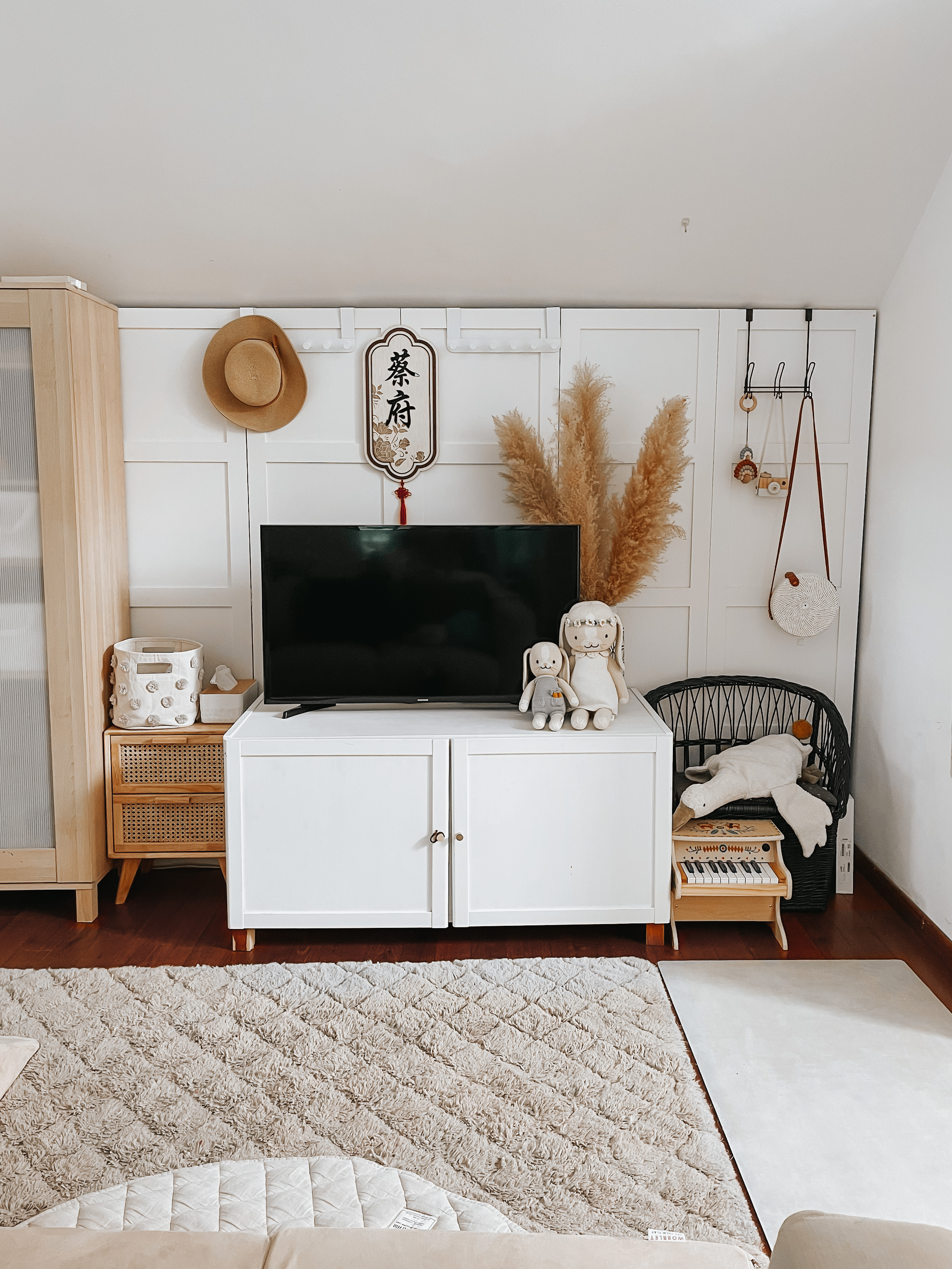 Living Room Makeover under $300 - White cabinet, fluffy rug, beige pillows, wooden furniture, decorative hat, rattan basket