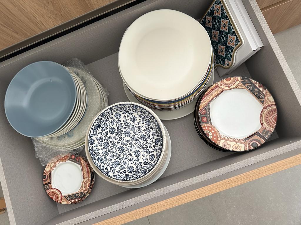 How I plan and organise my kitchen - Dining table, open drawer, ceramic plates, decorative plates, stacked plates, patterned