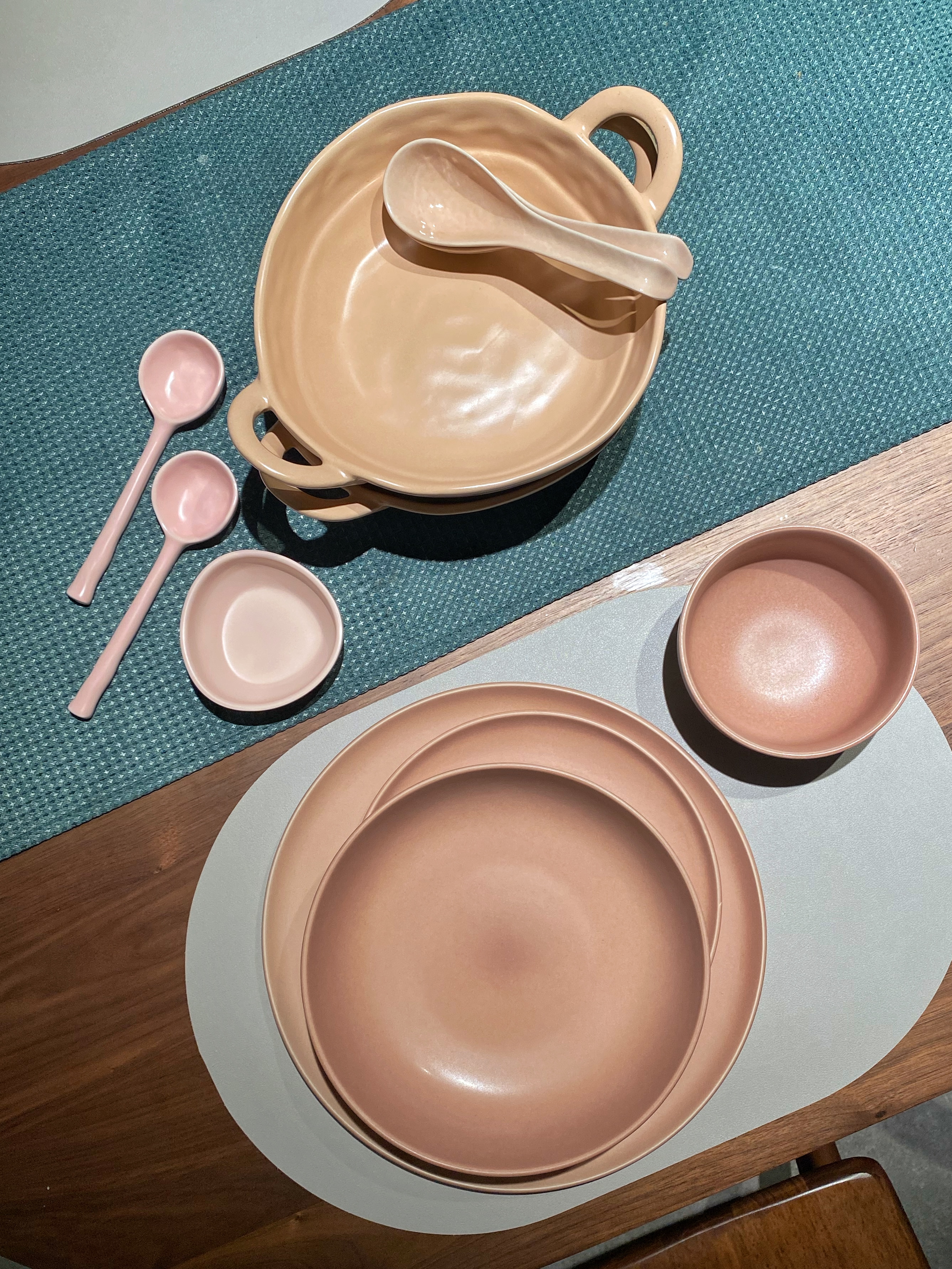 It all started with the color of the sofa...  - Muted beige ceramic plates, pink ceramic serving spoons, turquoise textured