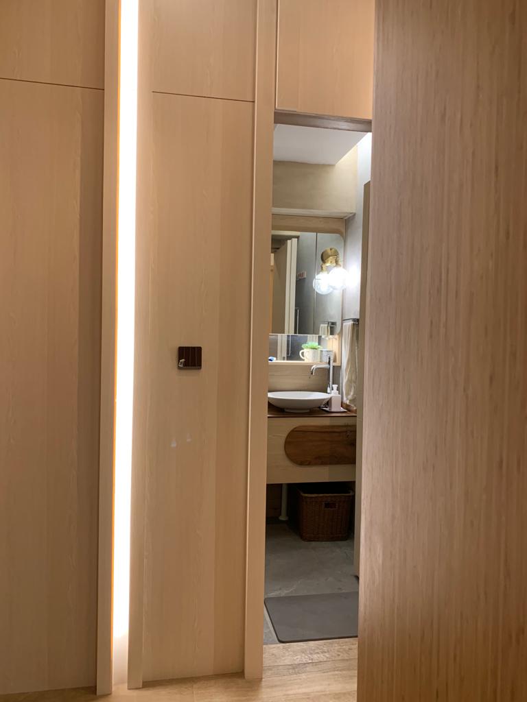 Japanese Inspired Interior | Bathrooms as a space to relax - Wooden door, modern bathroom, illuminated hallway, sleek design