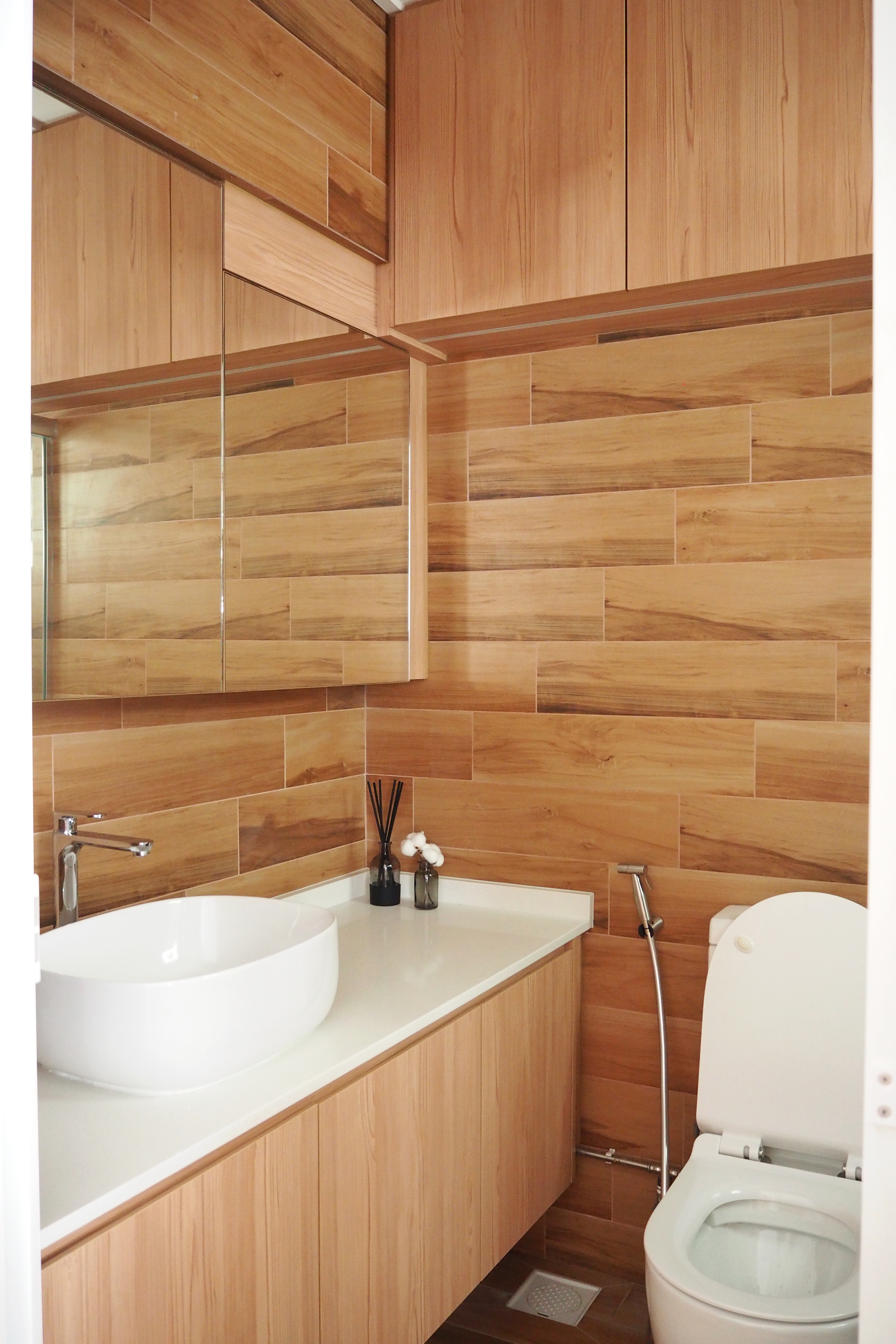 Bathrooms with Japanese Bath Vibes - Wooden cabinetry, modern design, sleek sink, white countertop, wooden wall tiles