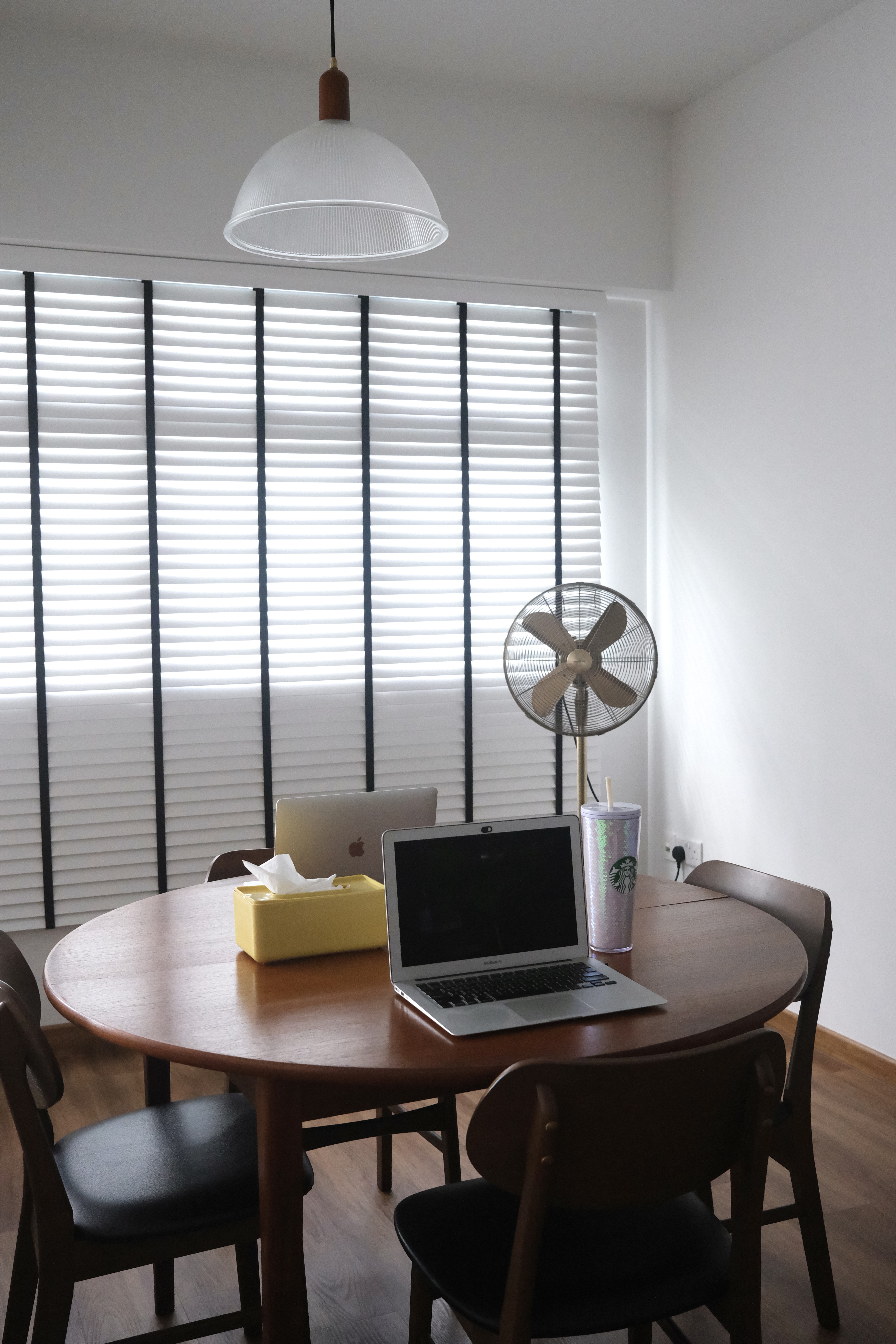 Dining Area | Where we work and relax  - Modern minimalist home office, natural light streaming through blinds, round wooden