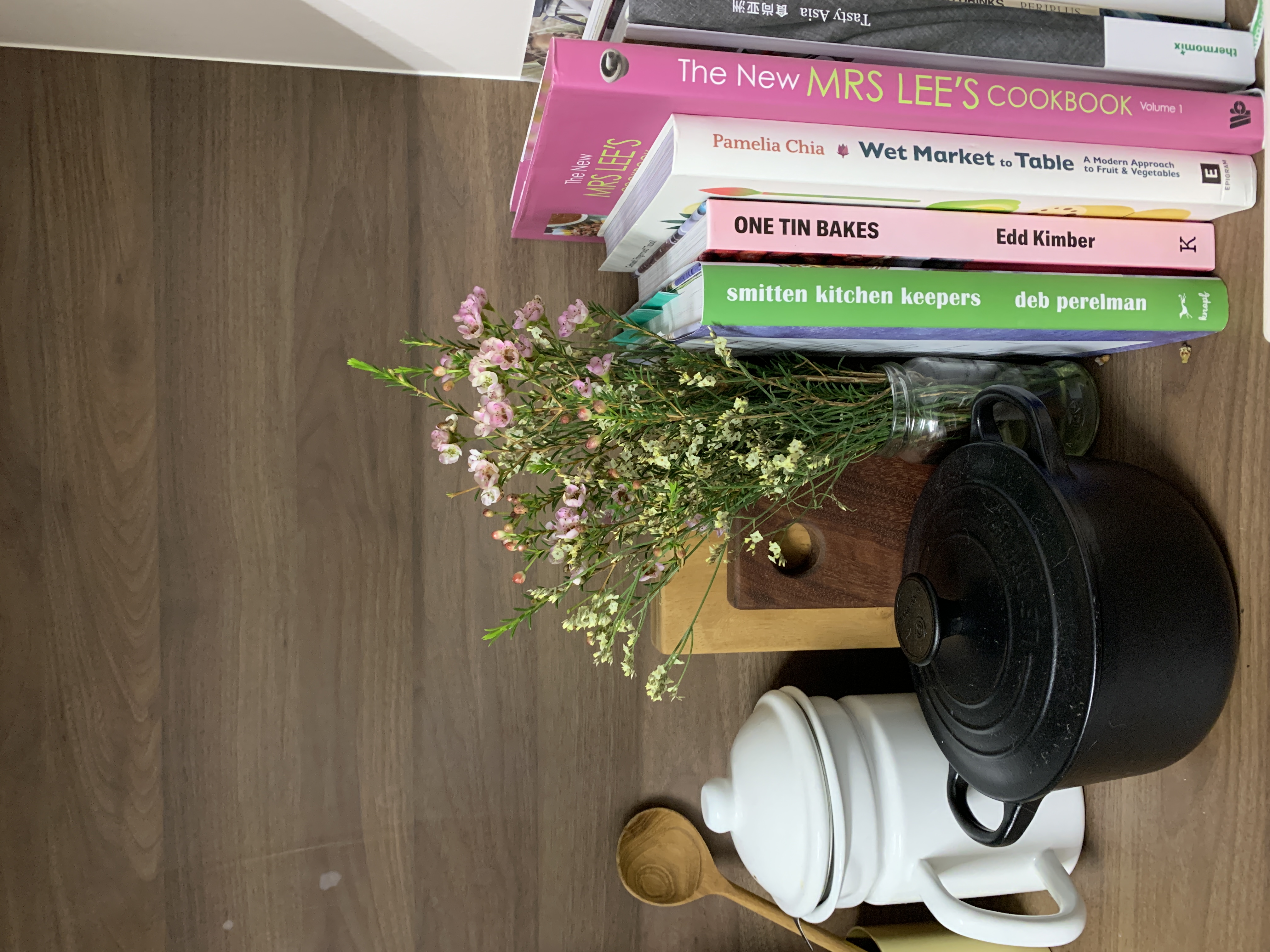 Little touches to add greenery through our home - Wooden floor, kitchen countertop, pink book, "The New Mrs. Lee's Cookbook