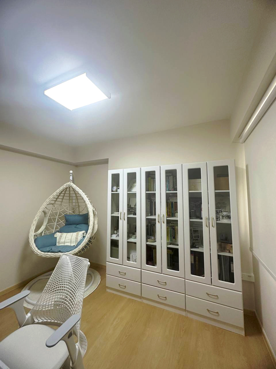 Embracing Simplicity - The Beige Minimalist Haven 🏠 - White wicker chair, wooden floor, minimalist decor, white bookshelf