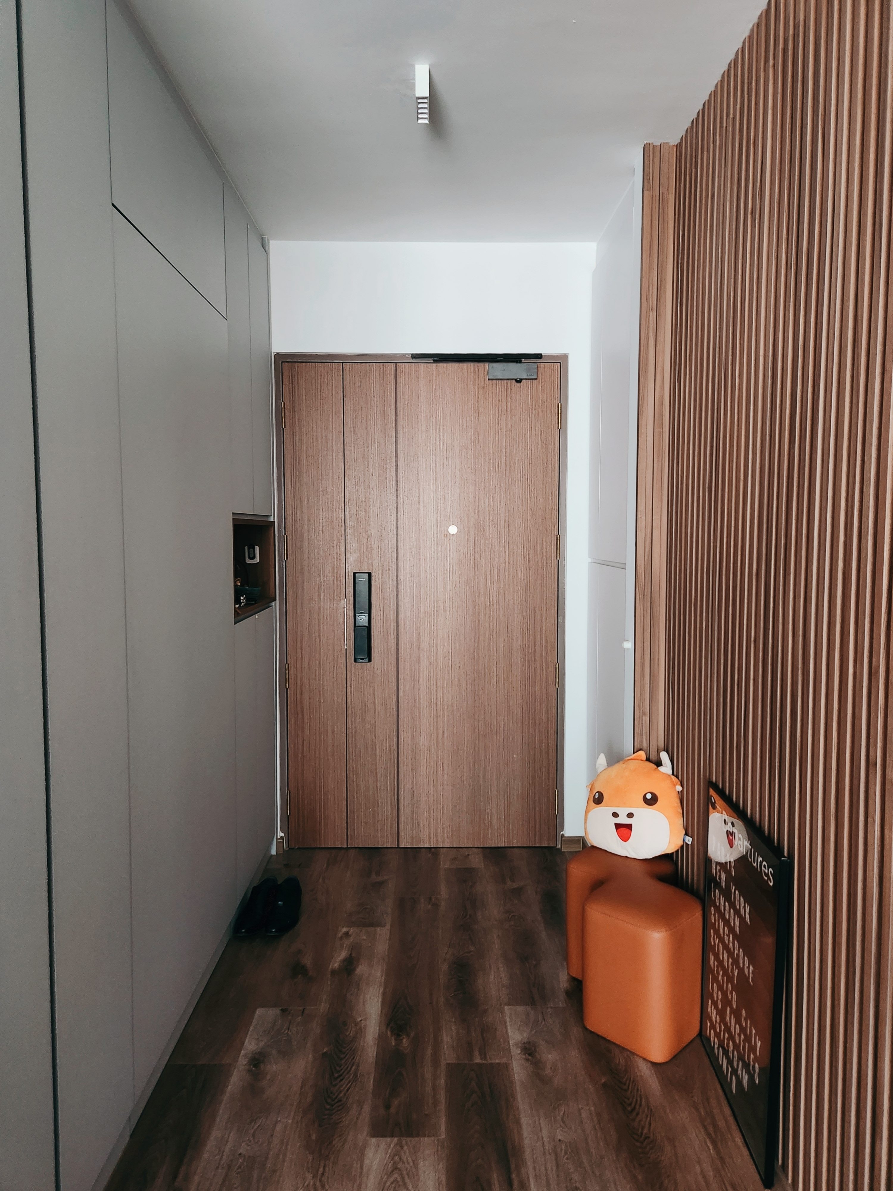 Who knew Fluted Panels can be so expensive?  - Modern minimalist hallway, wooden floor, sleek cabinets, wooden door, plush