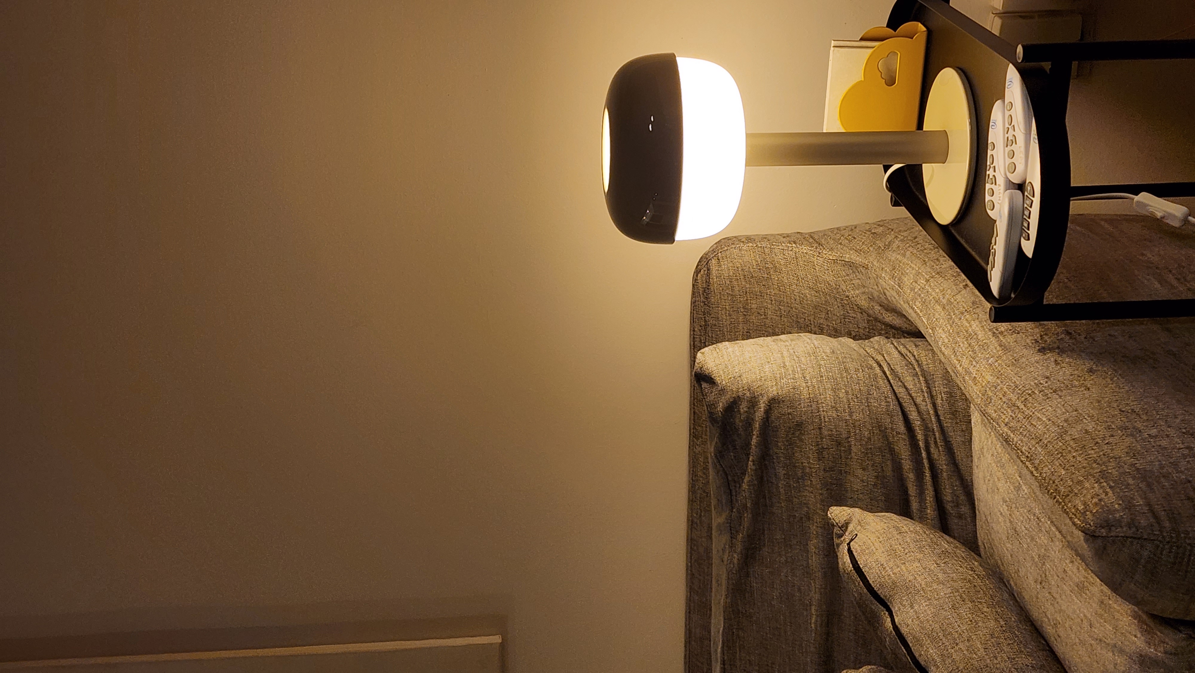 5 Lighting Ideas to Create Mood in your Home - Lamp with dual light sources, beige wall, modern design, textured sofa, cozy