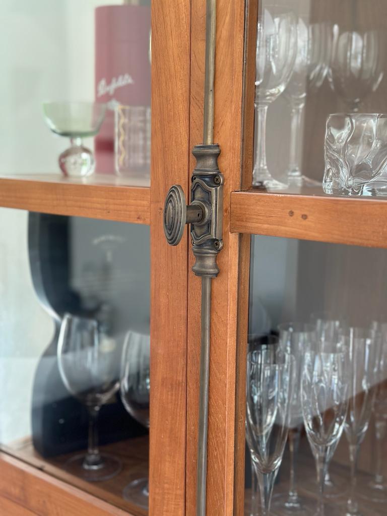 Indoor dining room with an outdoor feel - Wooden cabinet, glassware display, elegant design, vintage charm, intricate