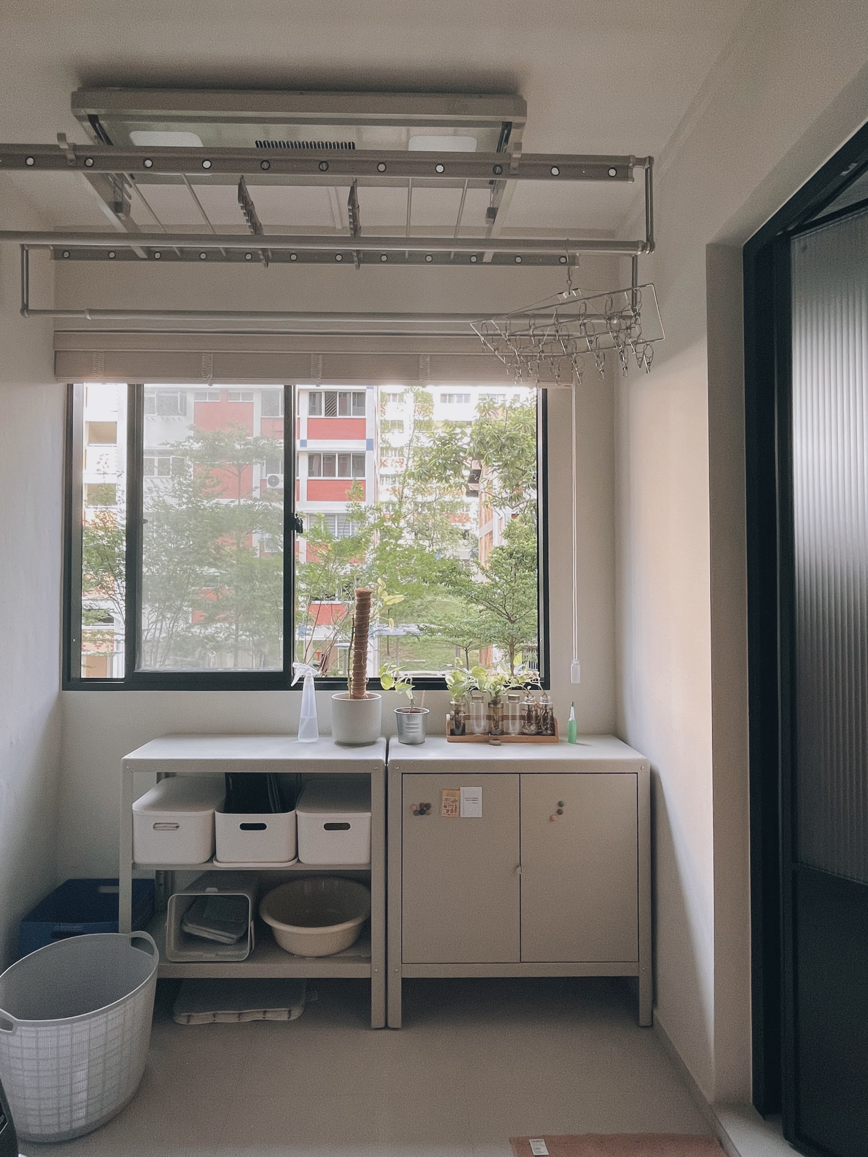 Optimising vertical space in this simple service yard - window sill, indoor plant, white shelving, utility cabinet, laundry