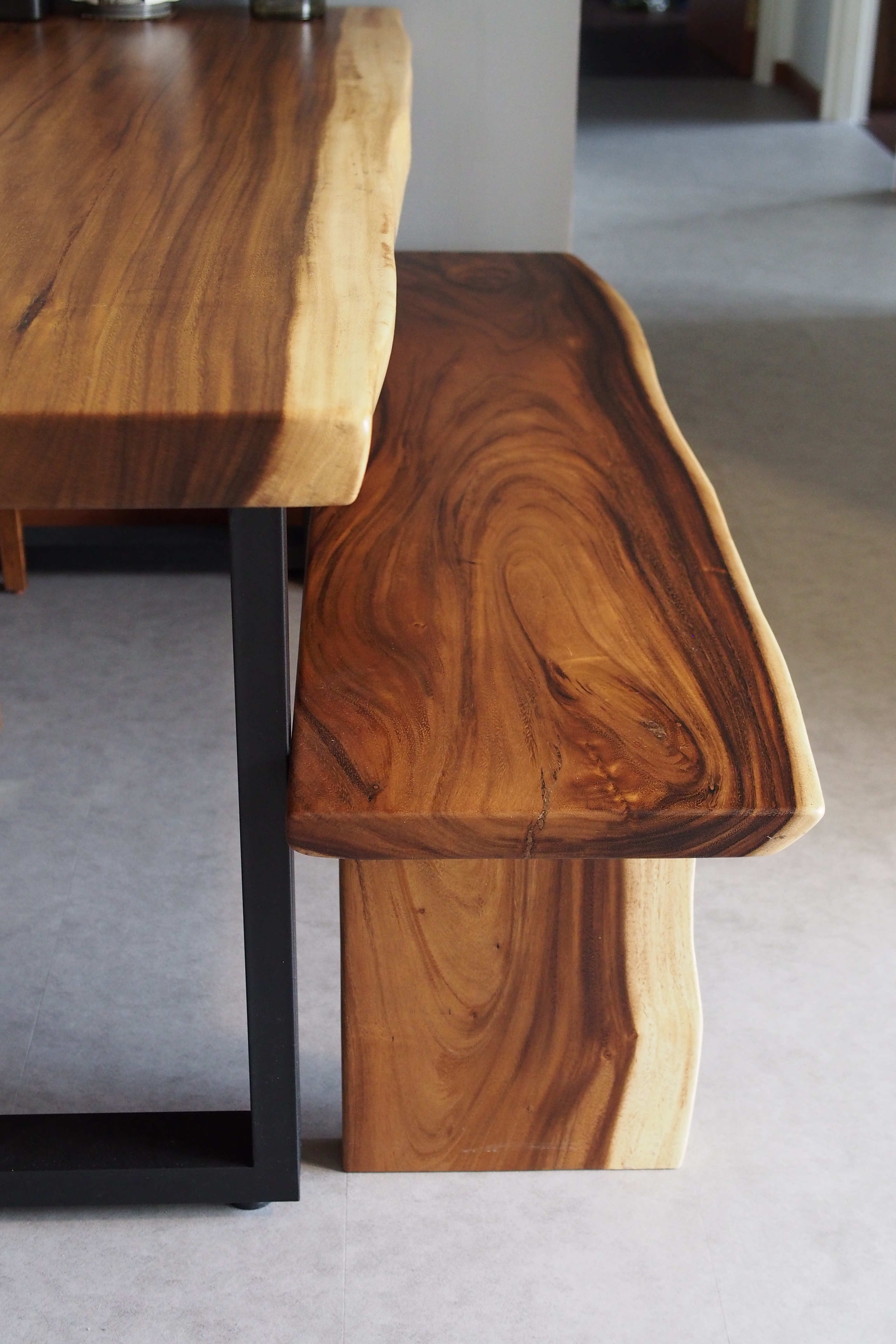 Adding a splash of colour to makan time - Wooden table with natural wood grain, black metal frame, curved leg design, warm
