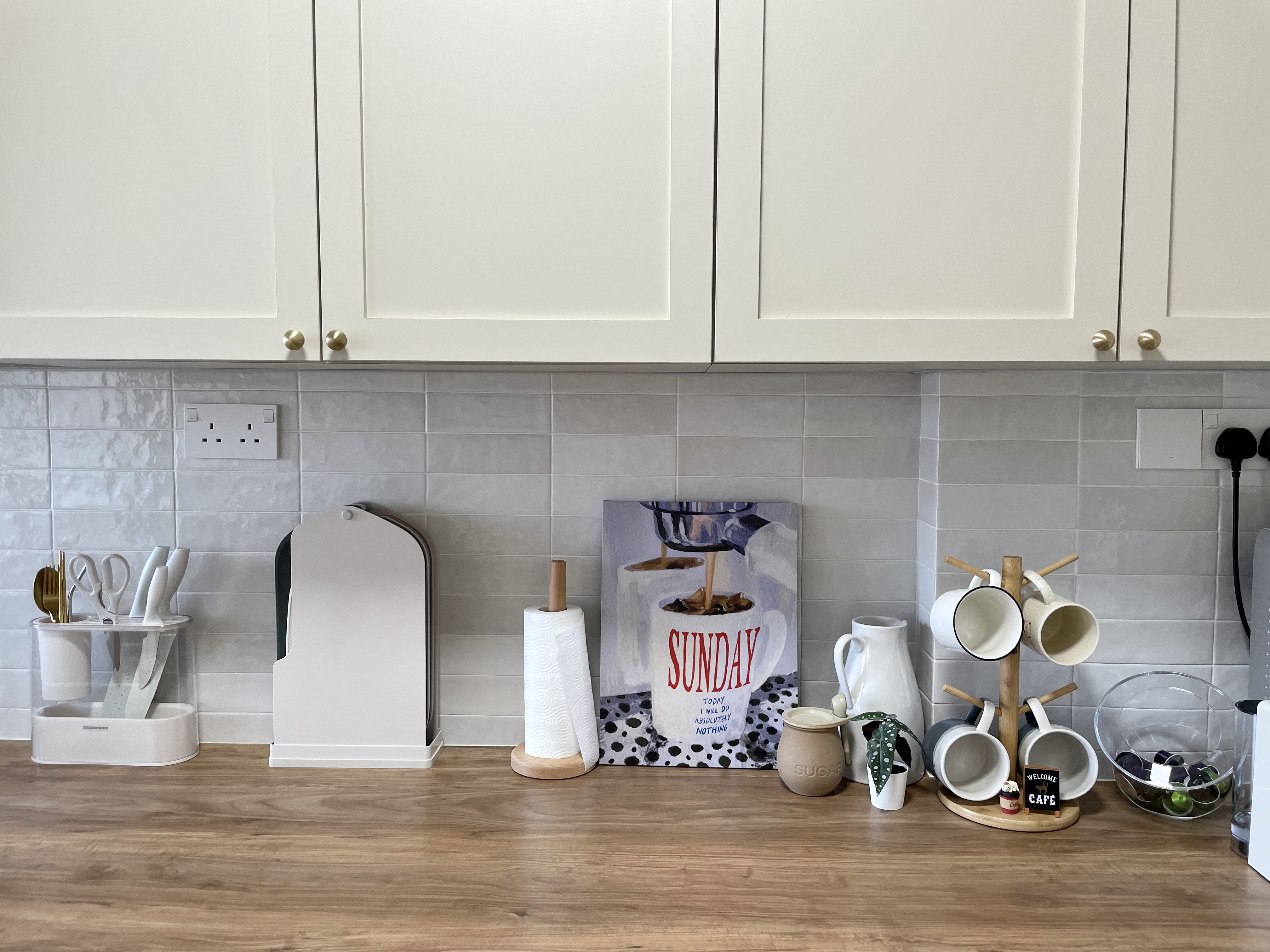 Kitchen organization with a balance for aesthetic - White kitchen cabinets, wooden countertop, minimalist design, modern