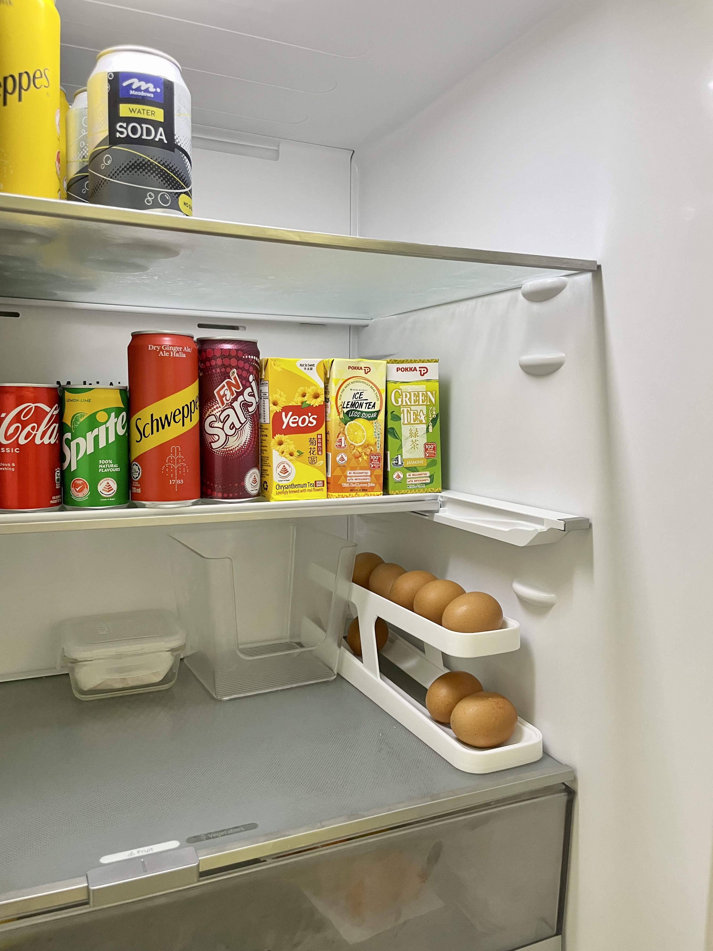 Kitchen organization with a balance for aesthetic - Freshly stocked refrigerator with various beverages, Variety of soda
