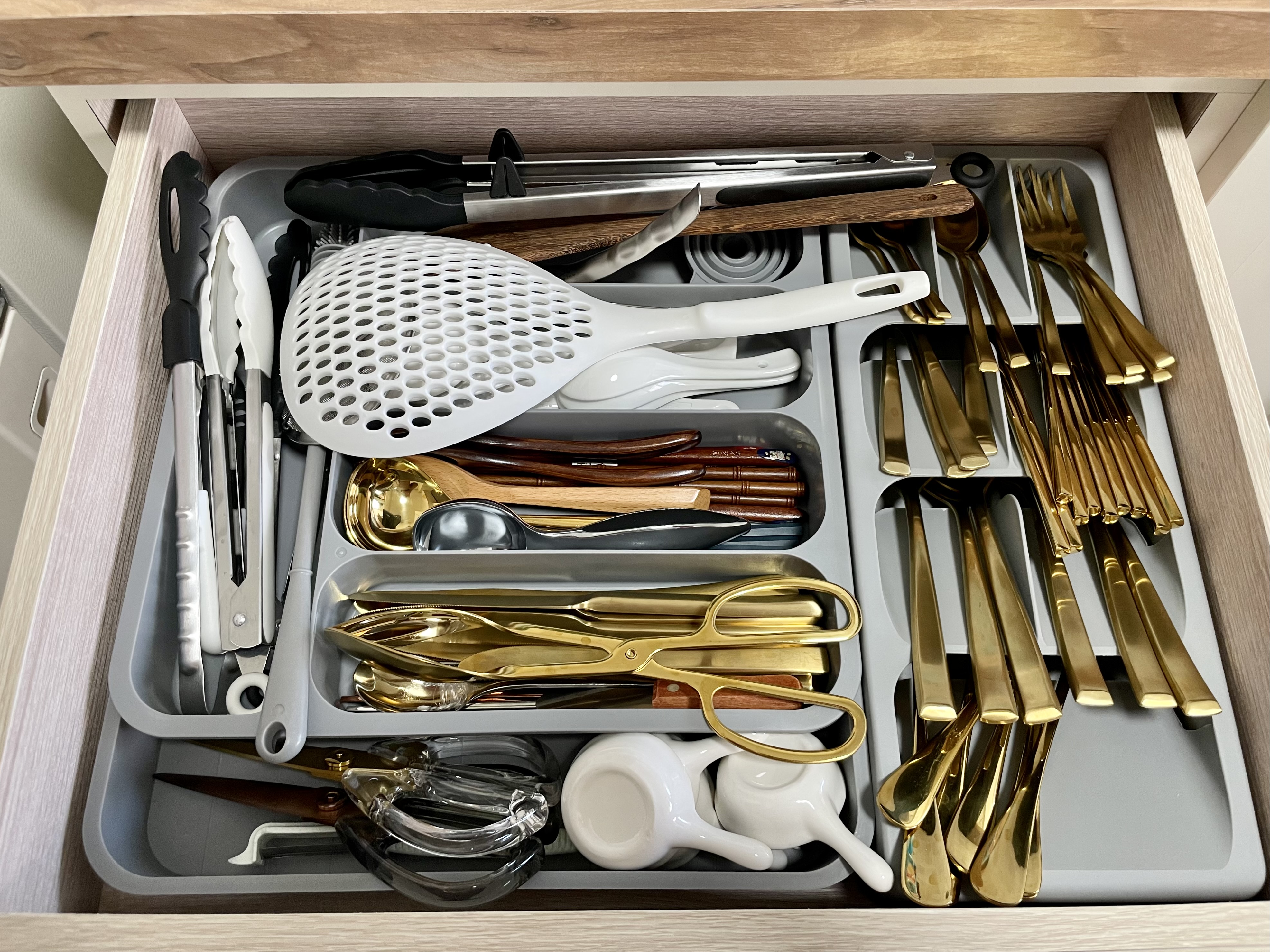 Kitchen organization with a balance for aesthetic - Kitchen utensils, organized drawer, stainless steel tools, wooden drawer