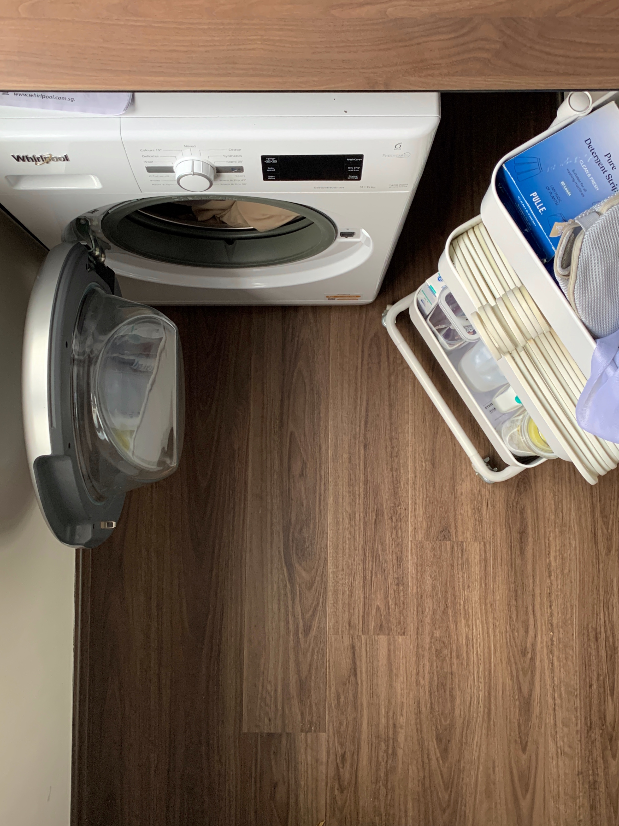 Simple and Clean: A compact laundry space! - Whirlpool washing machine, open lid, laundry detergent, white Whirlpool, wooden