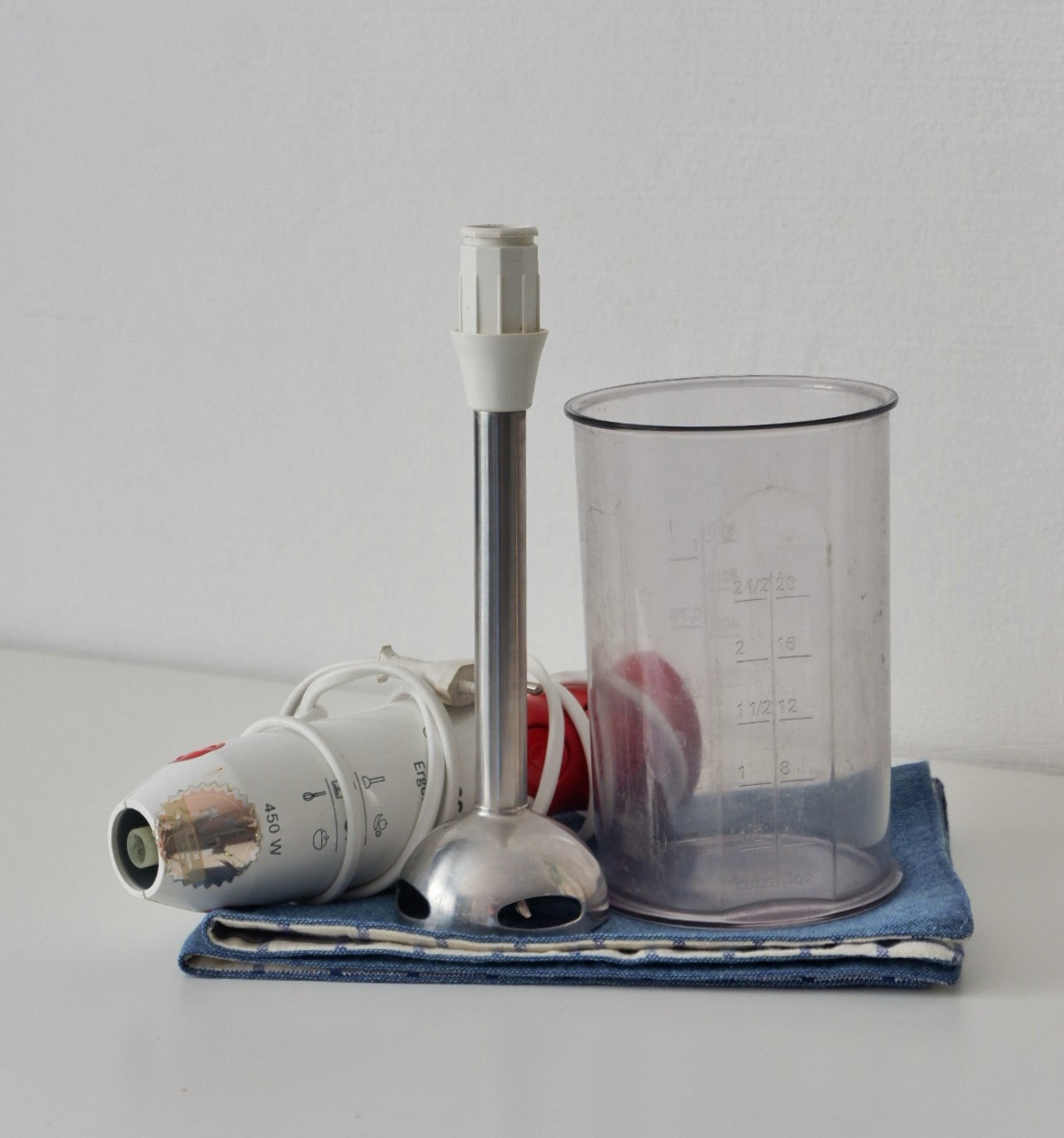 Kitchen purchases that I would recommend  - Clear measuring cup, metallic measuring spoon, white plastic bottle, red object