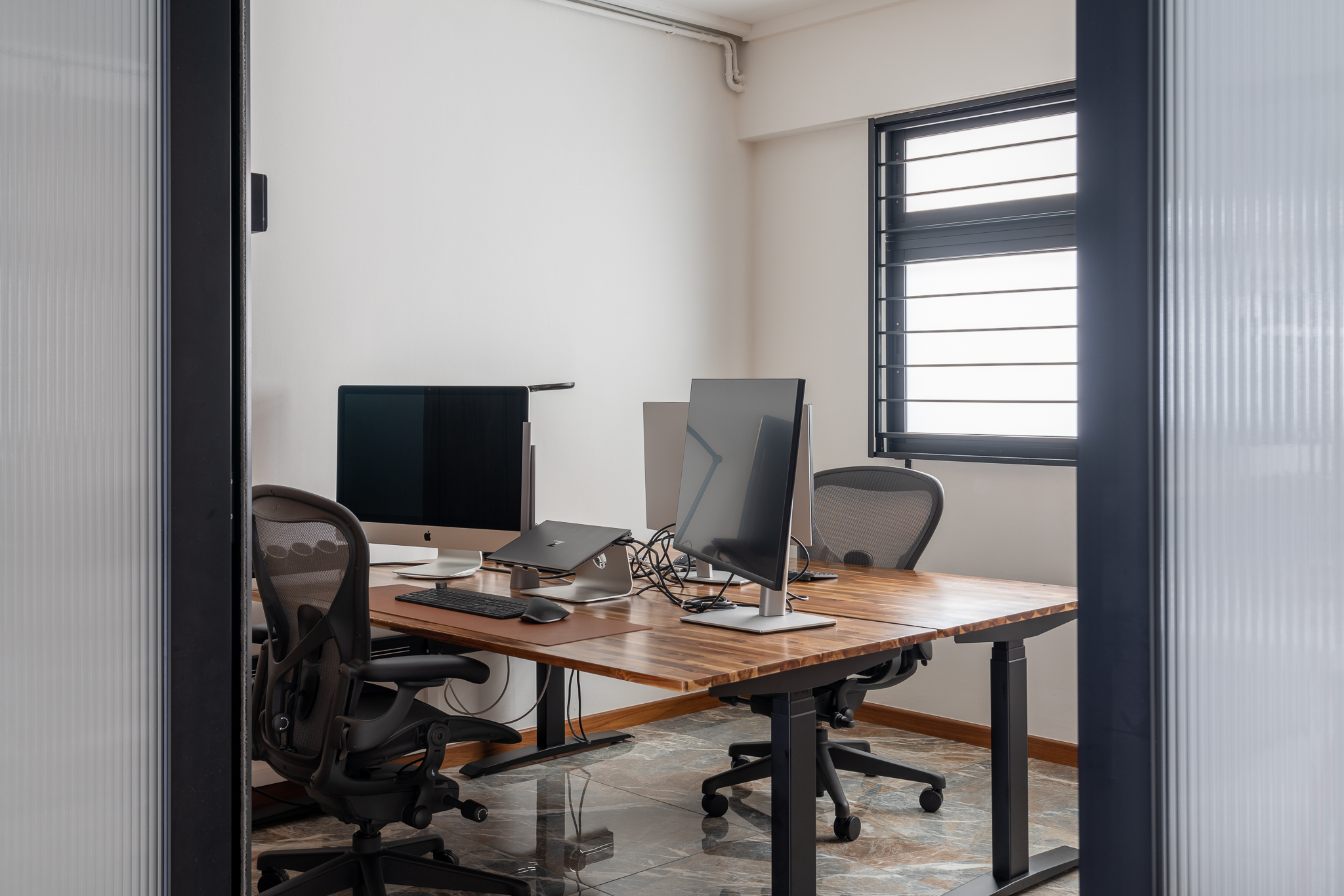 WFHappily Ever After - Modern workspace, minimalist design, open office, ergonomic chair, wooden desk, black office chair