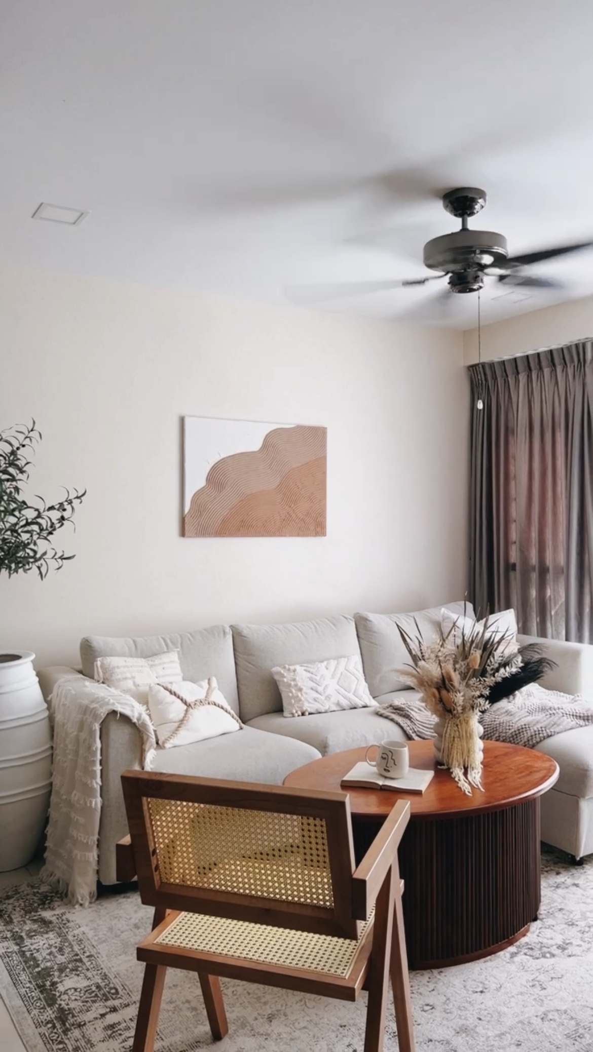 This is where we gather and connect ! - Modern living room, cozy seating, light-colored walls, abstract art, wooden coffee