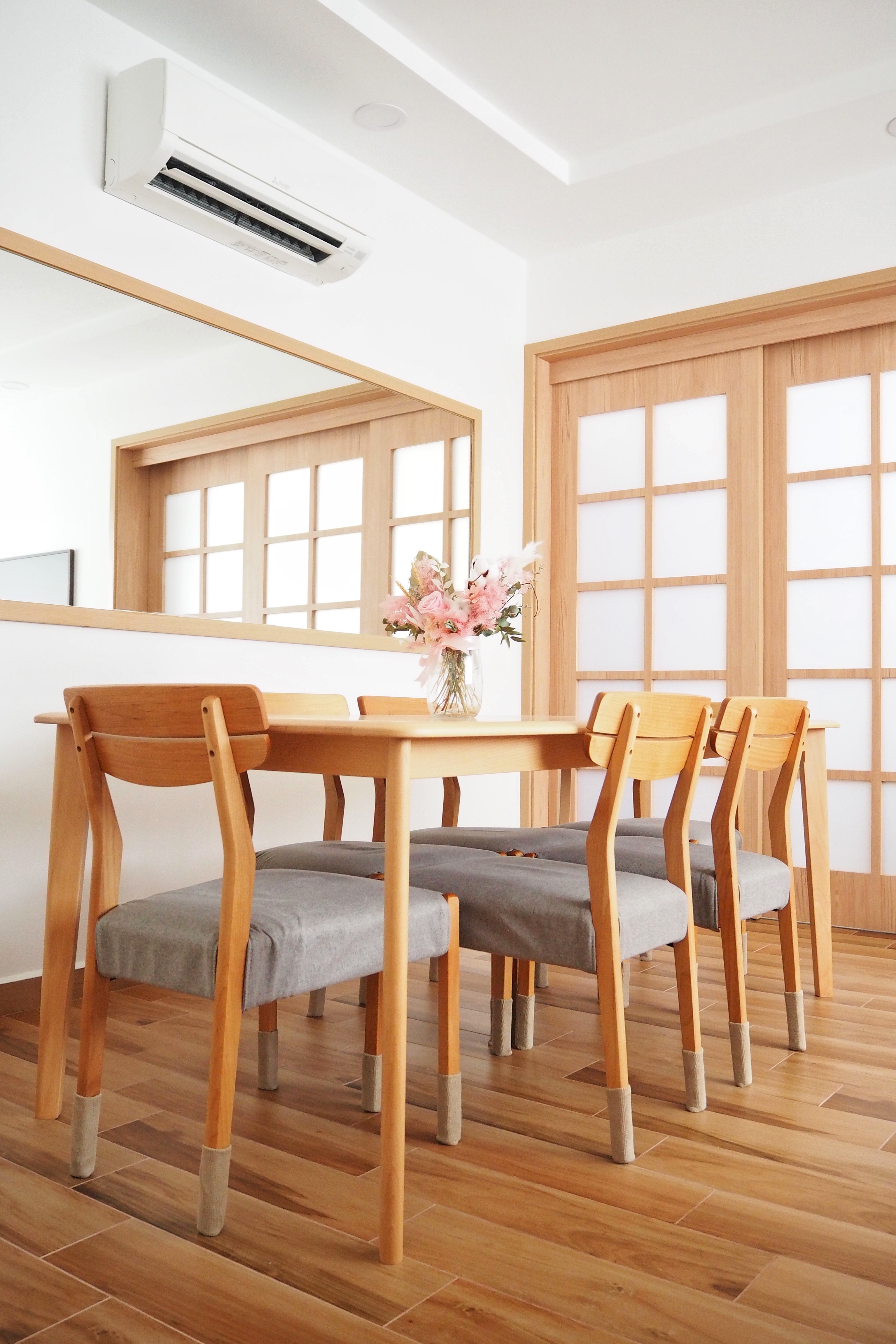 Our Serene Dining Space - Wooden dining table, light wooden chairs, gray cushioned seats, modern dining room, minimalist